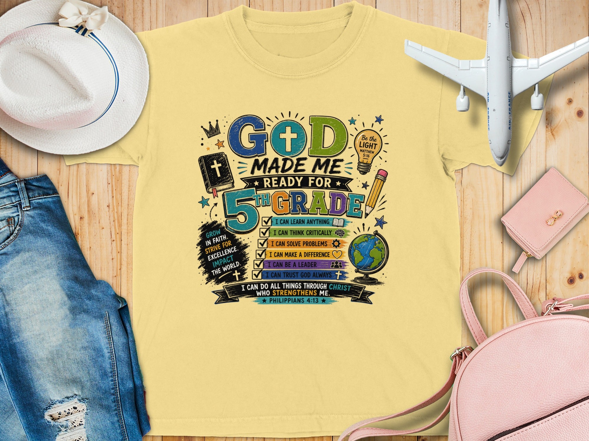"God made me for 5th grade" t-shirt with learning graphics, globe, and pencil.