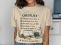 T-shirt with "CHECKLIST" and faith-based tasks, "A Teacher's Greatest Gift."