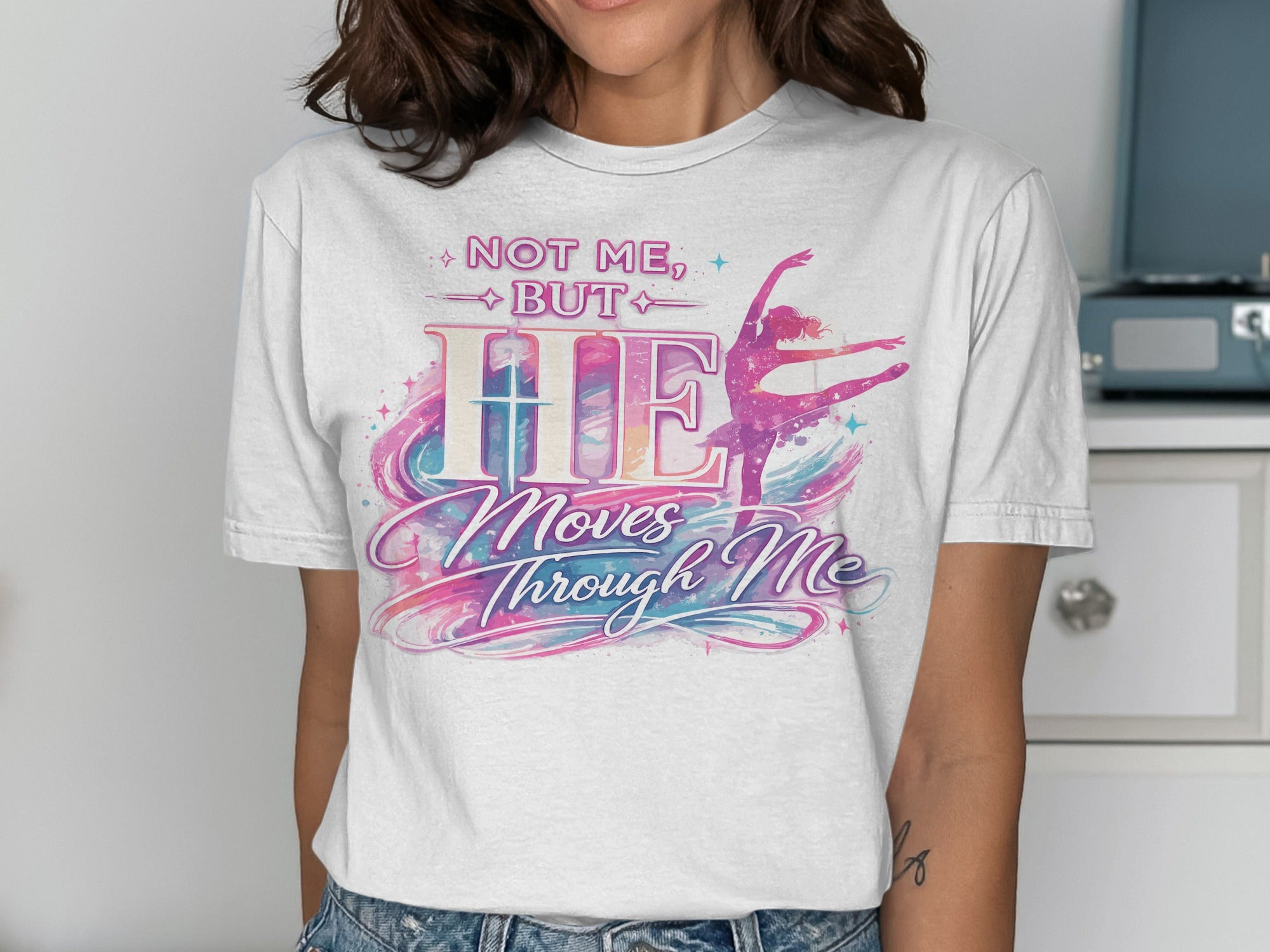 White t-shirt with "NOT ME, BUT HE Moves Through Me" and a ballet dancer.