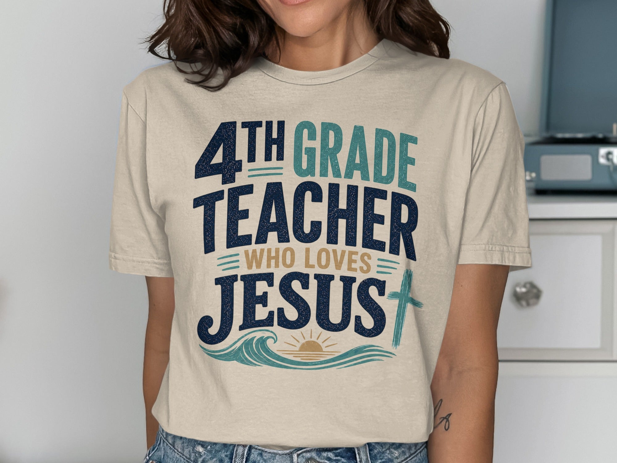 4th Grade Teacher Who Loves Jesus t-shirt with blue, tan, and cream text.
