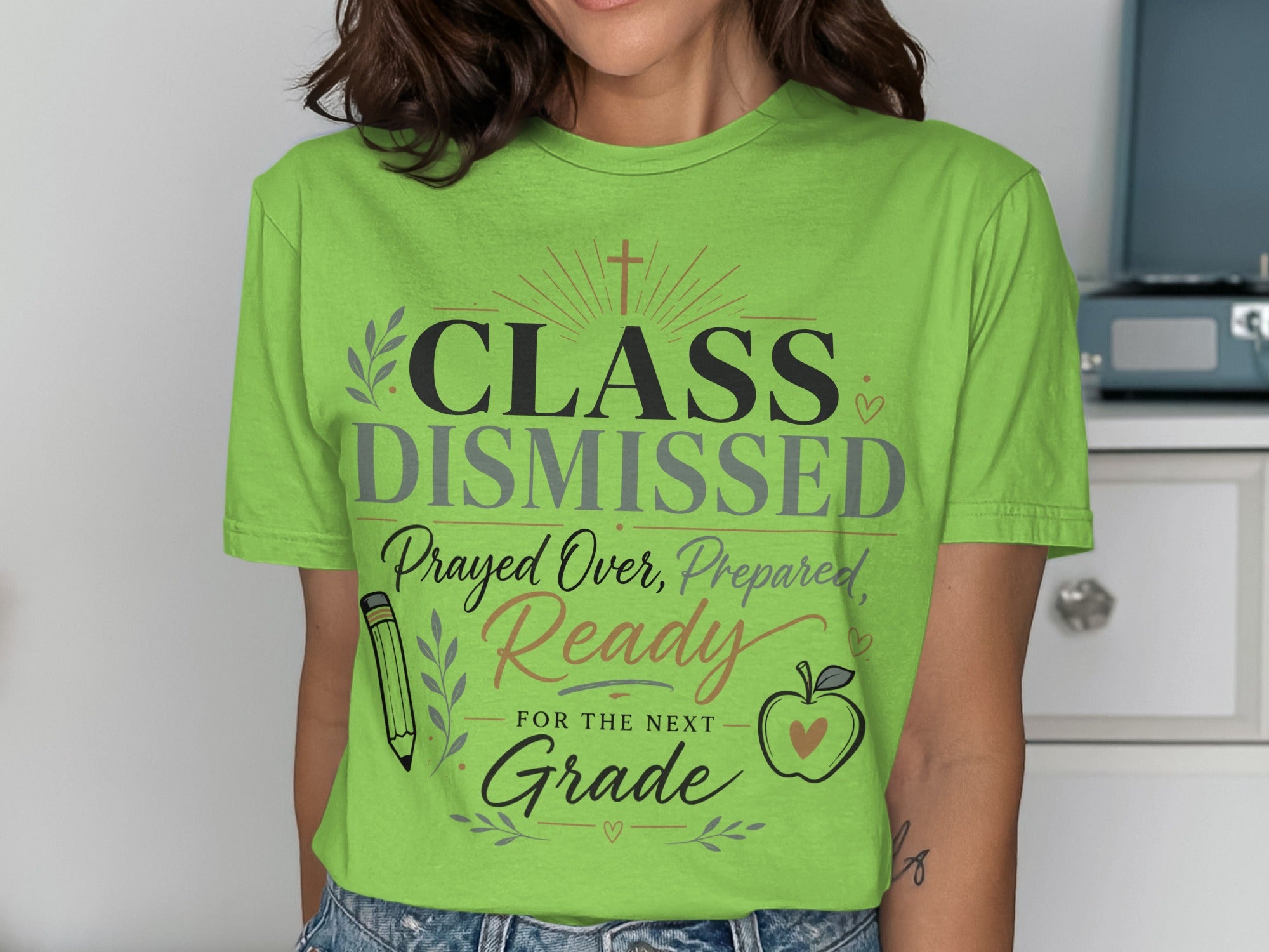 Green t-shirt with "Class Dismissed" and school-themed graphics.