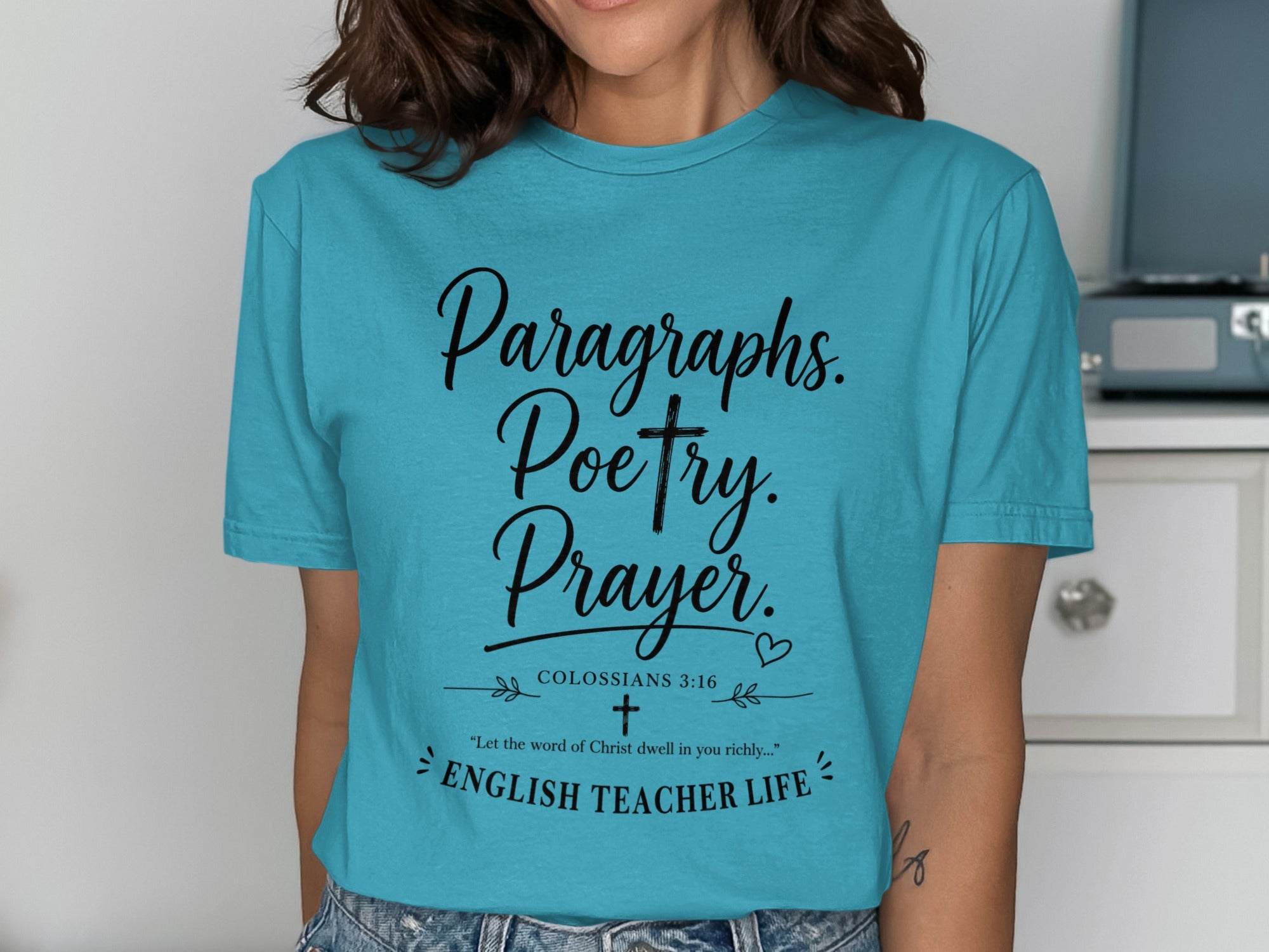 Teal t-shirt with "Paragraphs. Poetry. Prayer. Colossians 3:16 ENGLISH TEACHER LIFE" text.