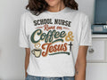 White t-shirt with text "School Nurse Runs on Coffee & Jesus" and coffee cup graphic.