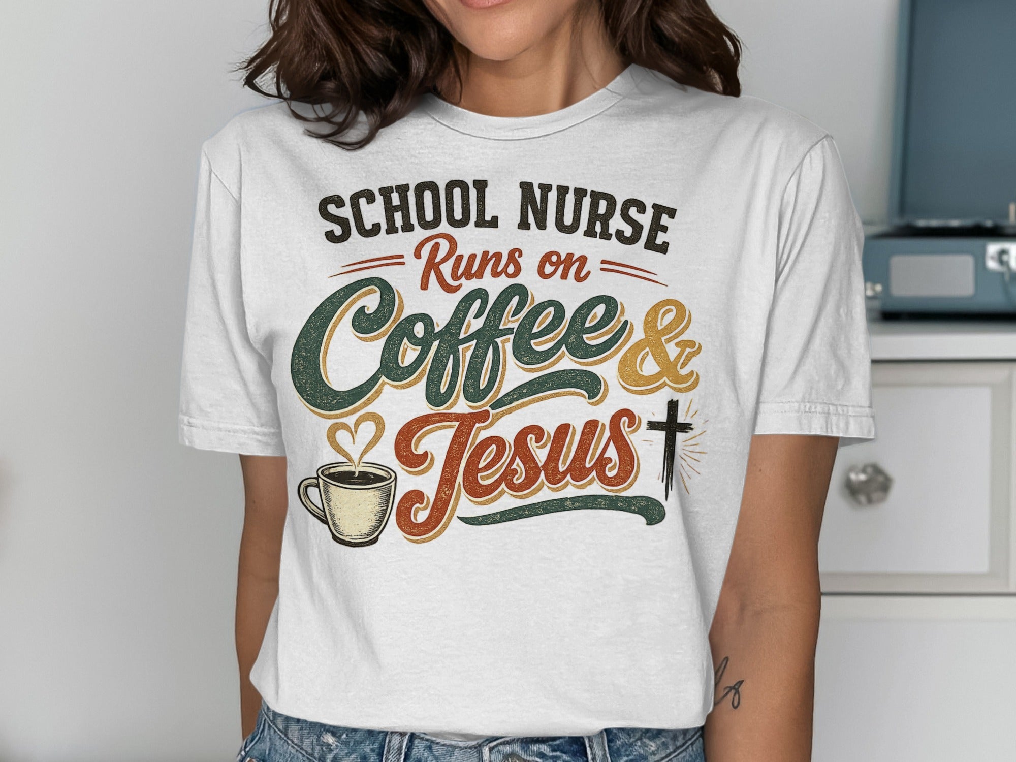 White t-shirt with text "School Nurse Runs on Coffee & Jesus" and coffee cup graphic.