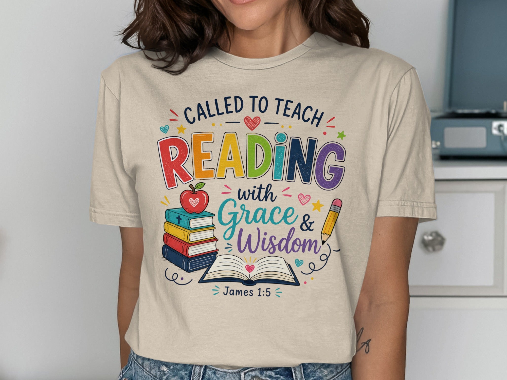 T-shirt with "Called to Teach Reading with Grace & Wisdom James 1:5" graphic.