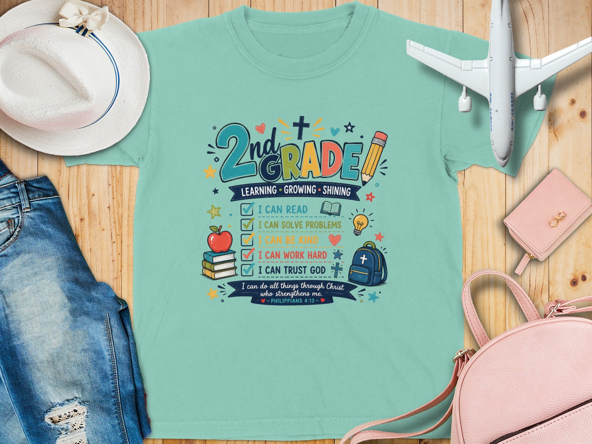 Green t-shirt with "2nd Grade" text and motivational phrases.