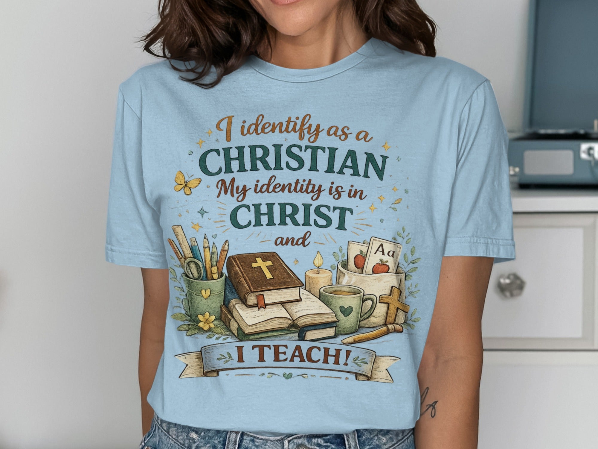 Light blue t-shirt with "I identify as a CHRISTIAN. My identity is in CHRIST and I TEACH!"