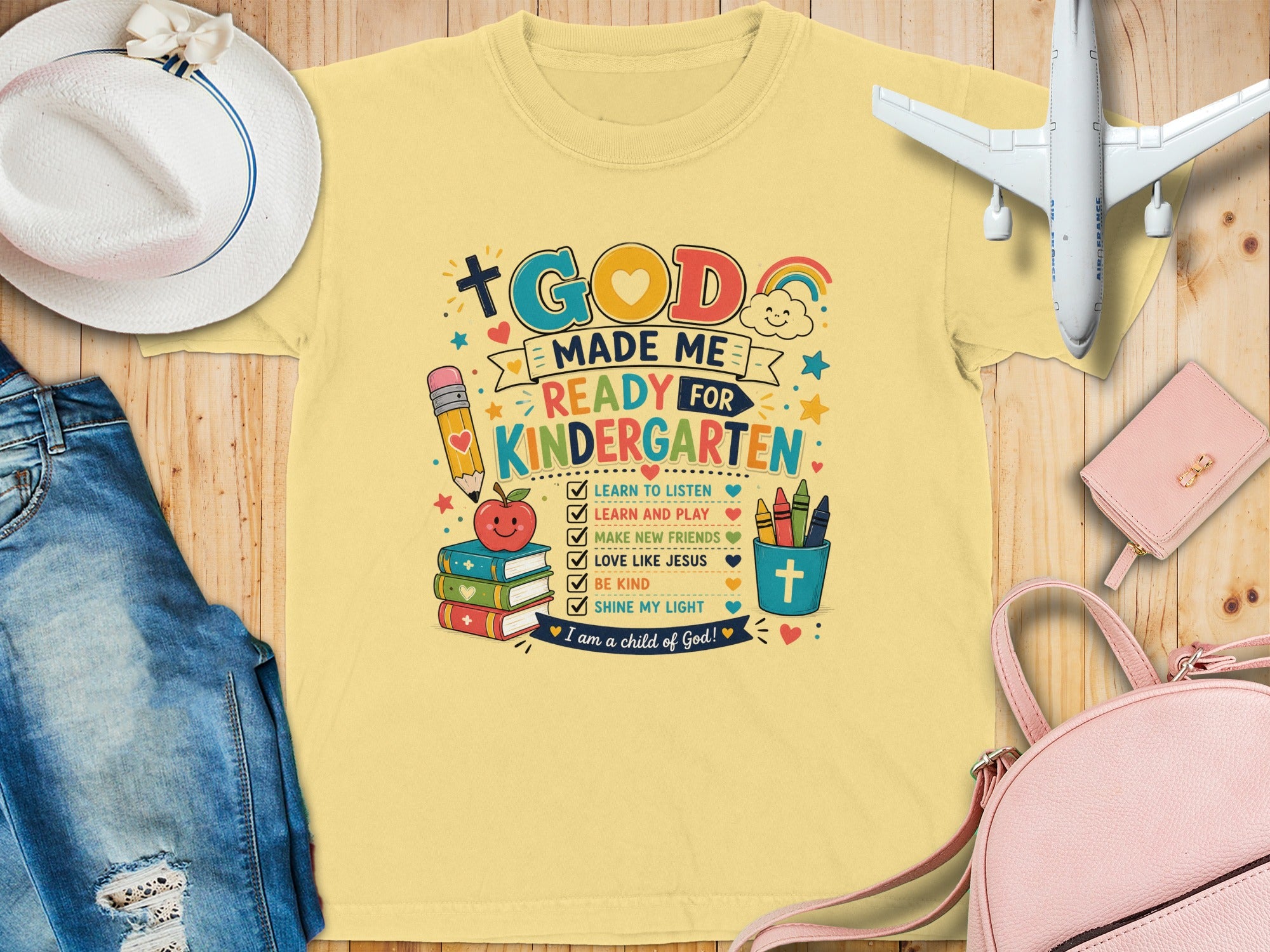 Yellow t-shirt with "God Made Me Ready for Kindergarten" and classroom graphics.