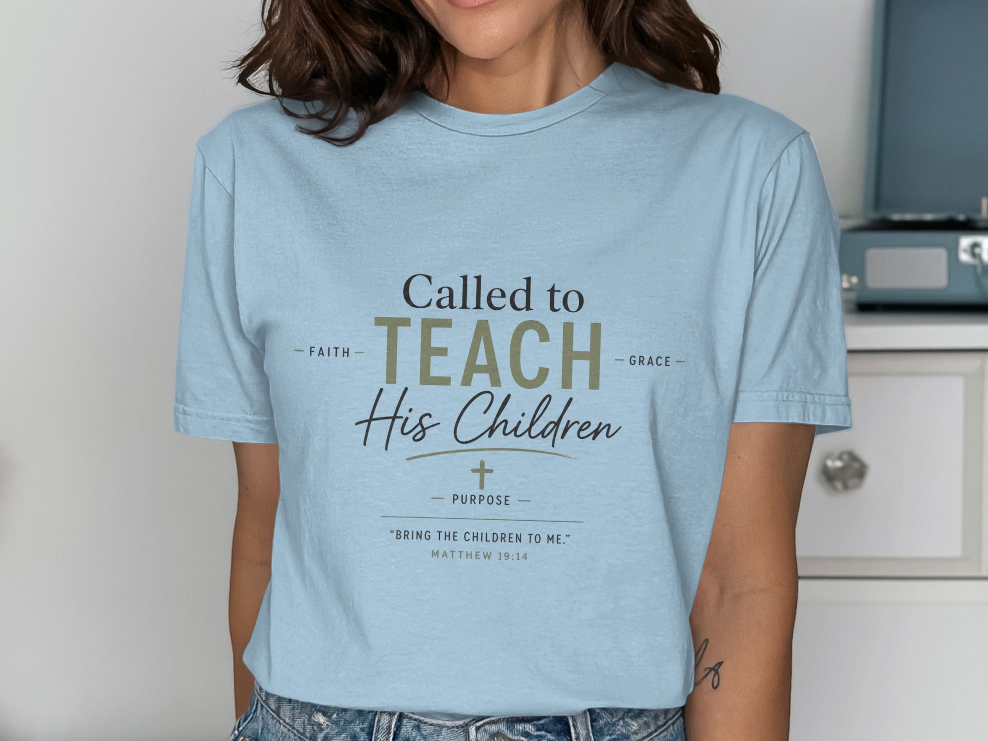 Light blue t-shirt with "Called to Teach His Children" and Bible verse.