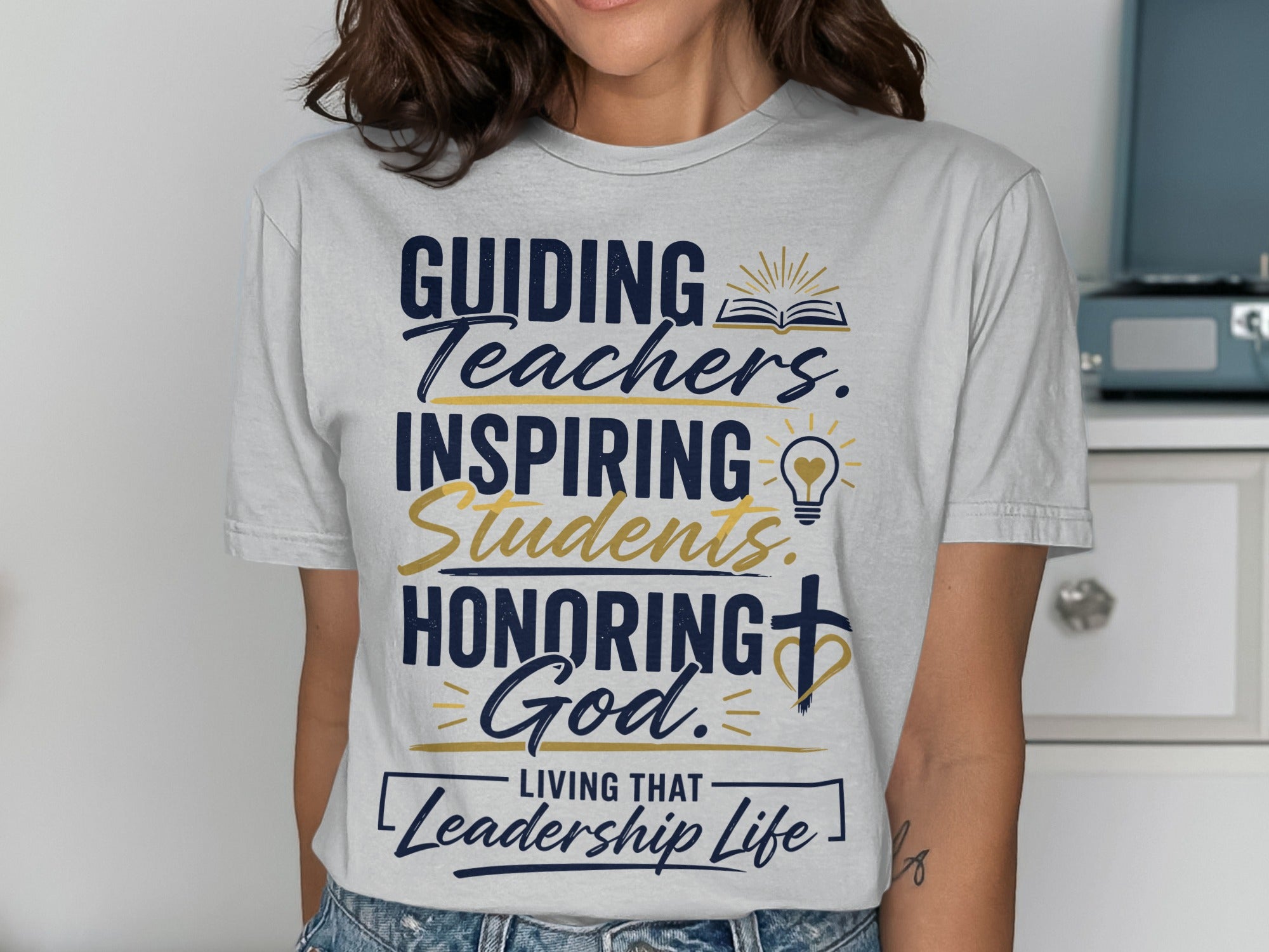 T-shirt with text "Guiding Teachers, Inspiring Students, Honoring God, Living that Leadership Life."