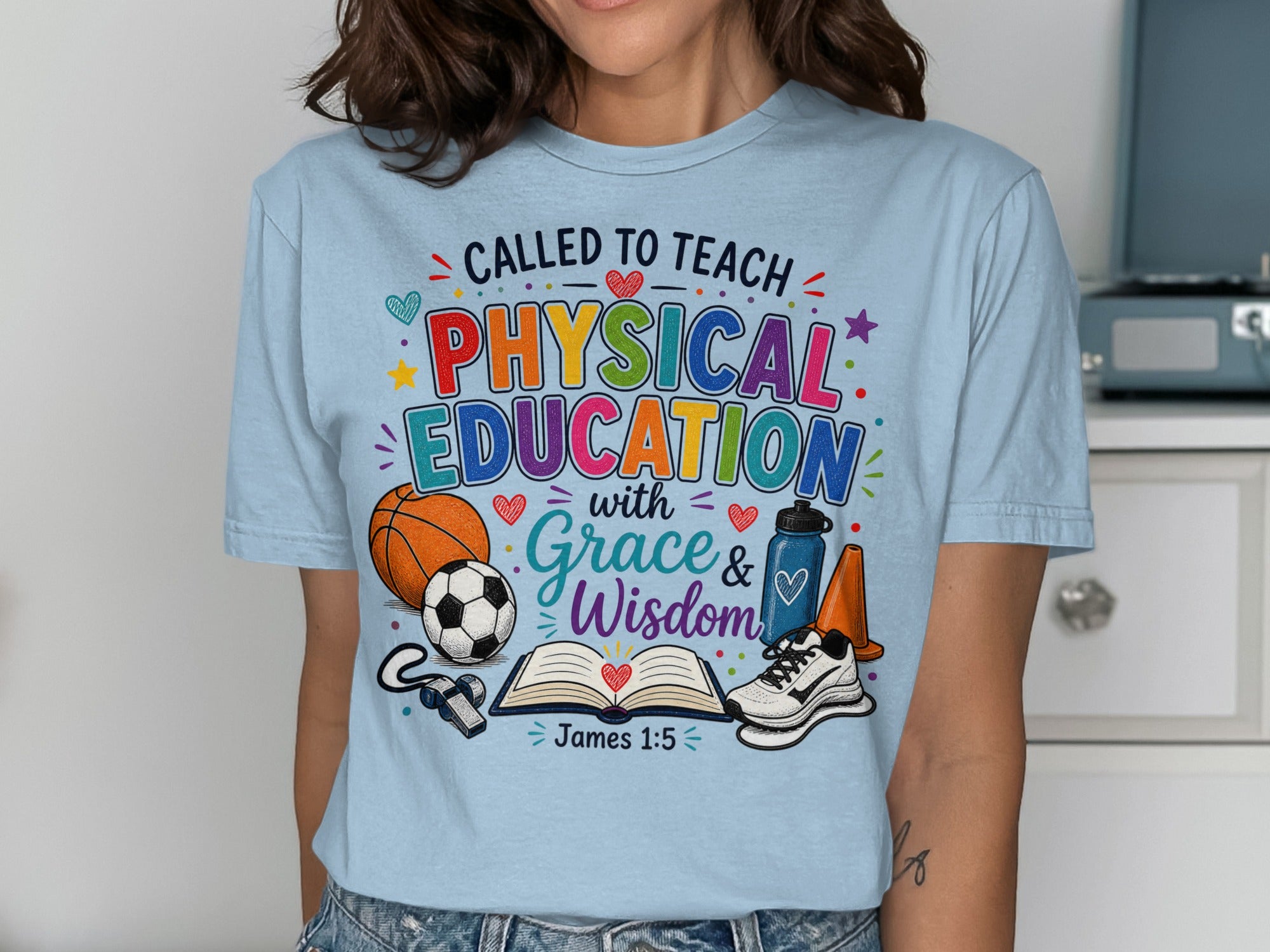 Blue t-shirt with "Called to Teach Physical Education with Grace & Wisdom James 1:5" and sports icons.