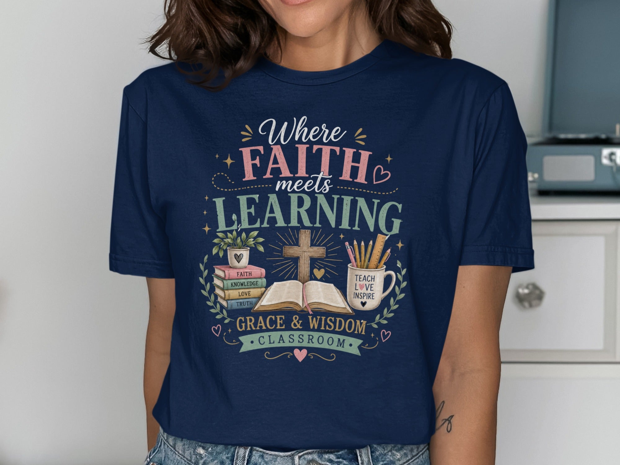 Navy t-shirt with "Where Faith Meets Learning" and religious/educational graphics.