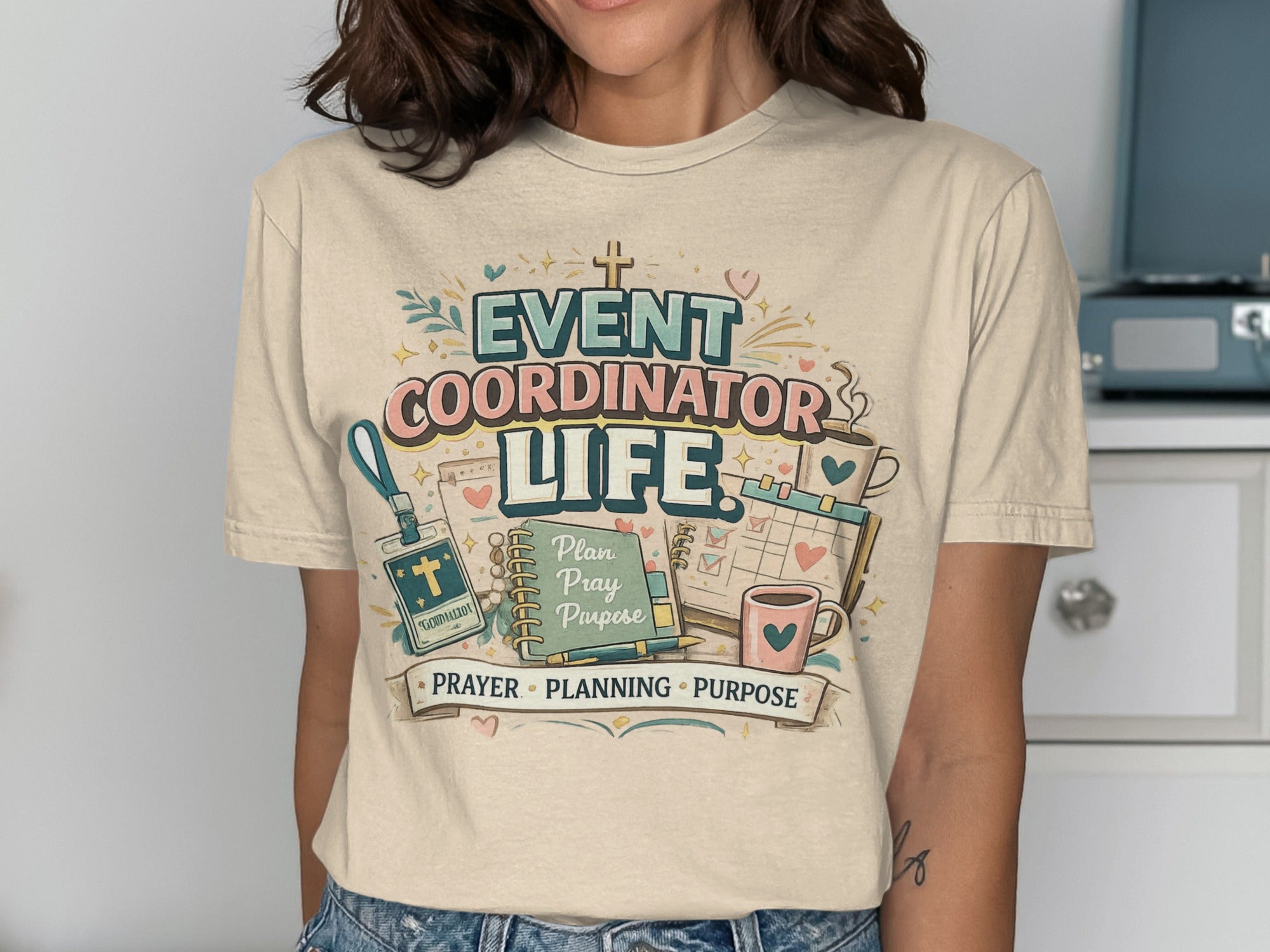 Event Coordinator Life: Prayer, Planning, Purpose graphic on a tan t-shirt.