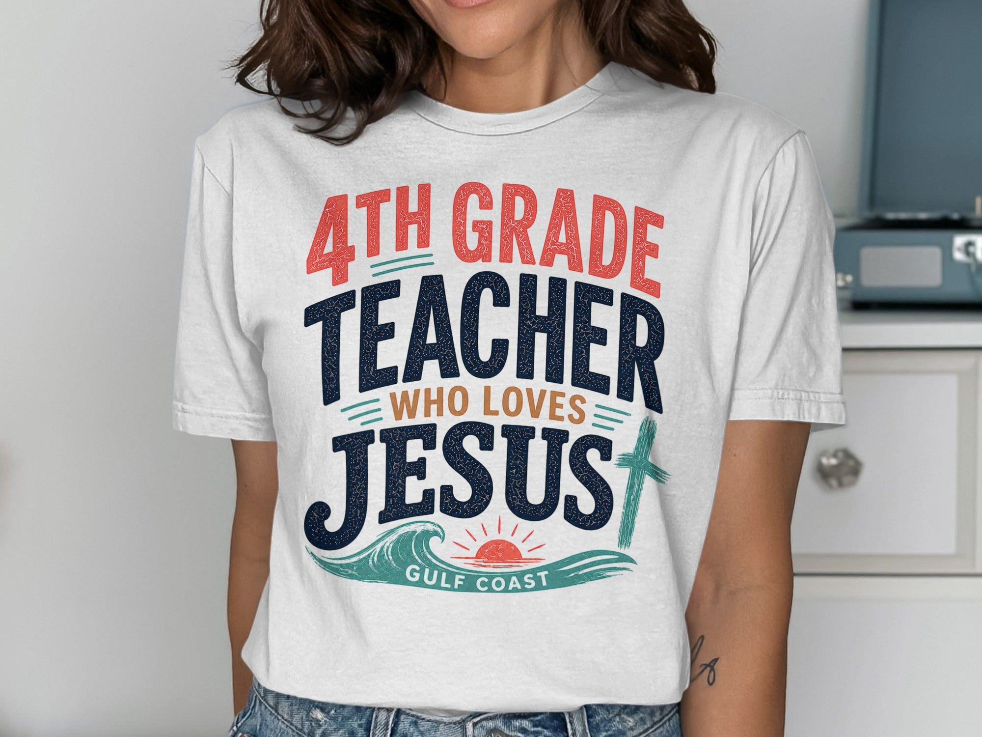 White t-shirt with "4th Grade Teacher Who Loves Jesus" and a cross.