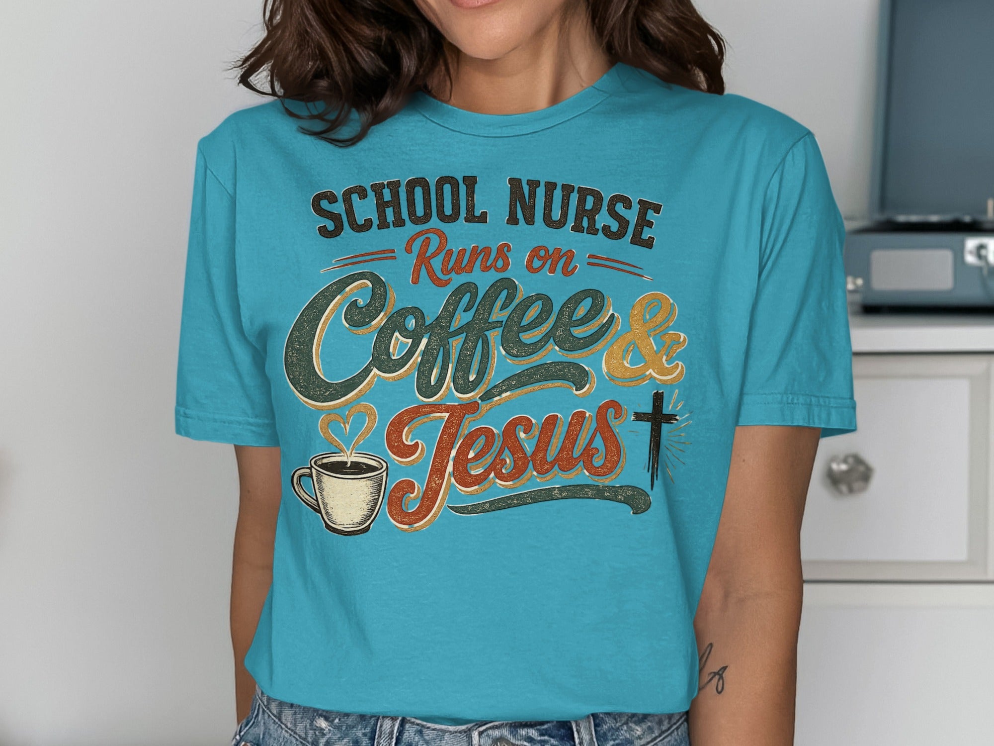 Blue t-shirt with "School Nurse Runs on Coffee & Jesus" text, heart, and cross.