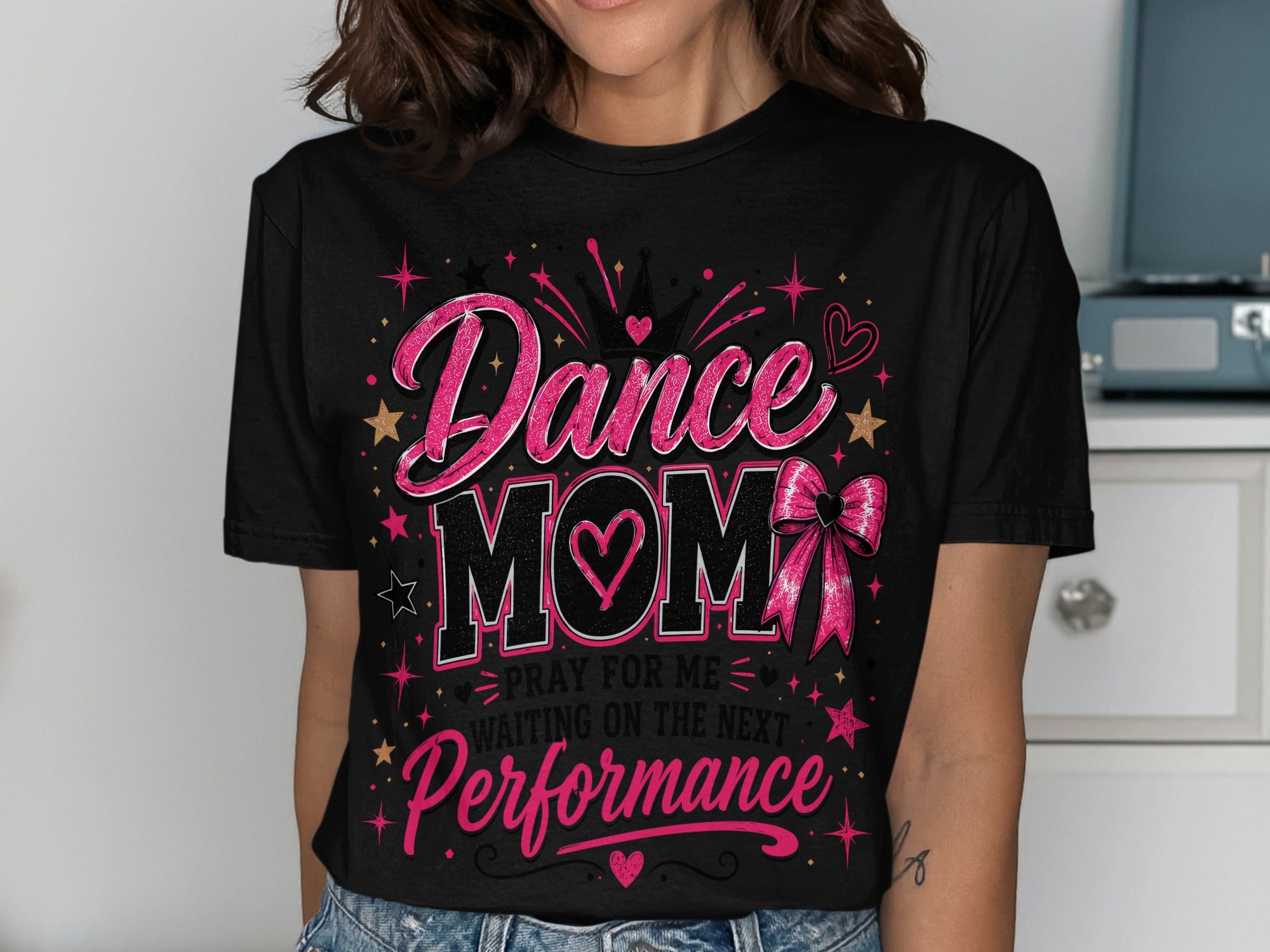 Black t-shirt with "Dance Mom" text, crown, heart, and bow graphic.