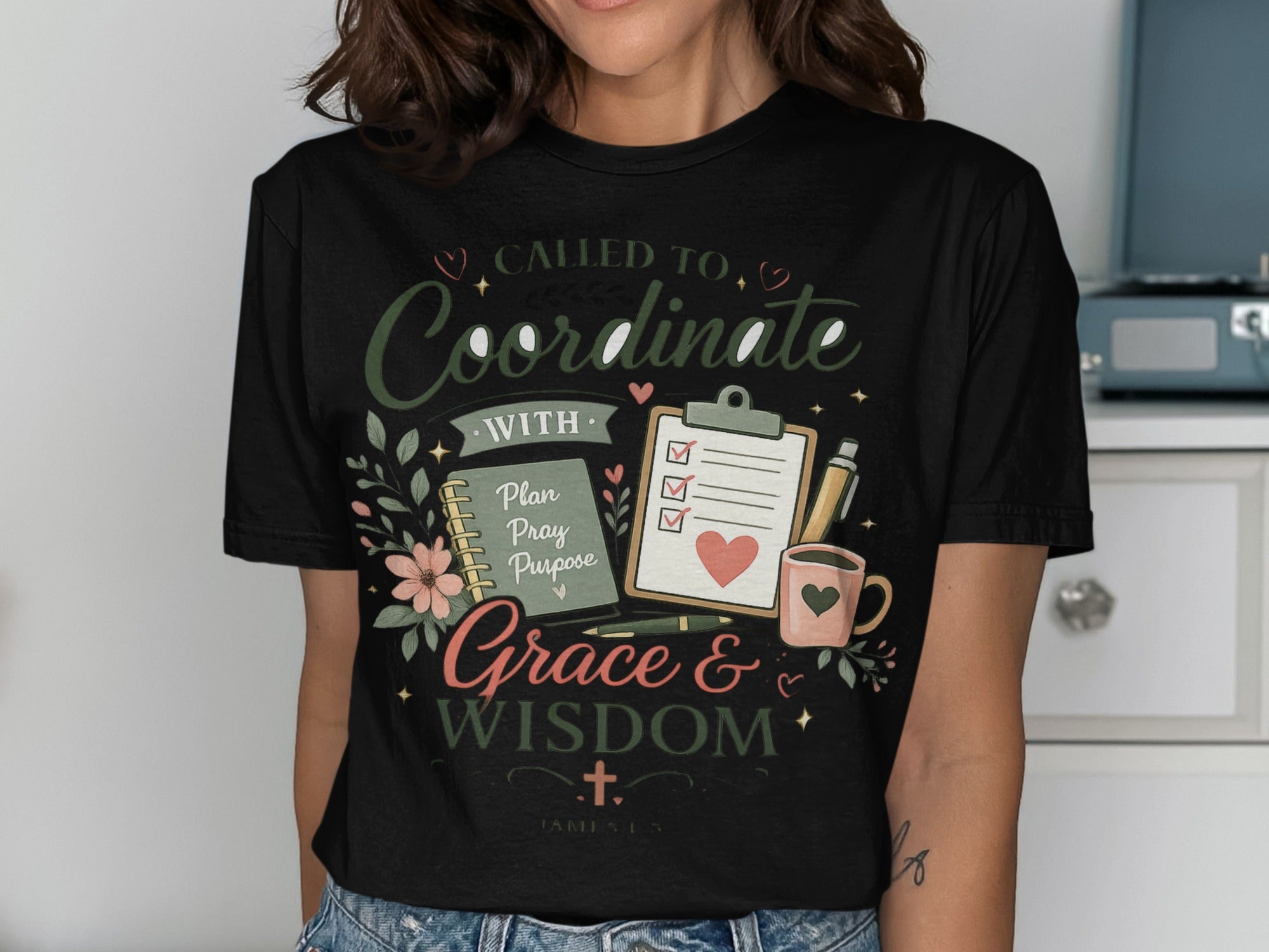 Black t-shirt with "Called to Coordinate with Grace & Wisdom" and notebook.