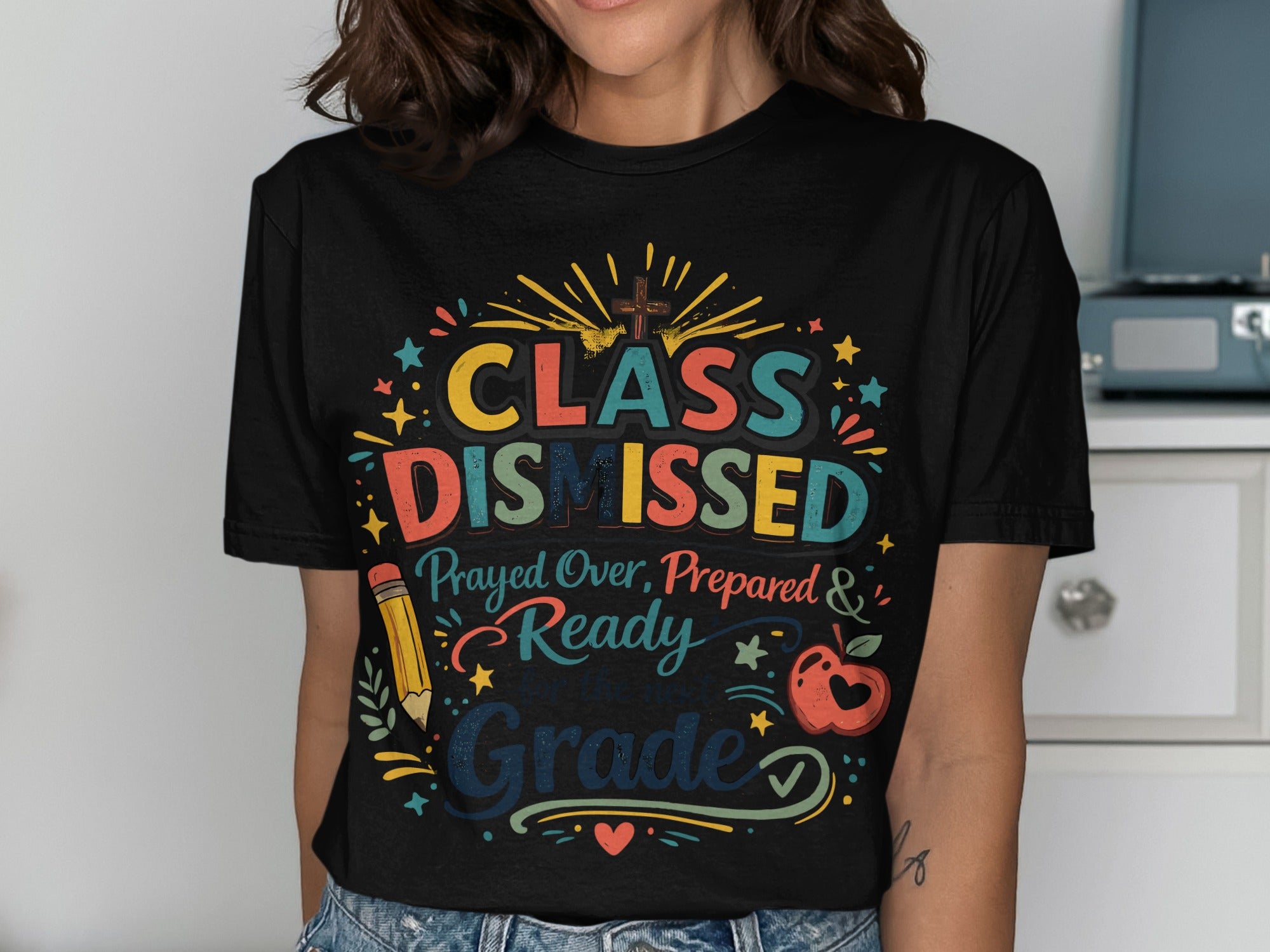 T-shirt with "Class Dismissed" text, apple, pencil, and cross graphic.