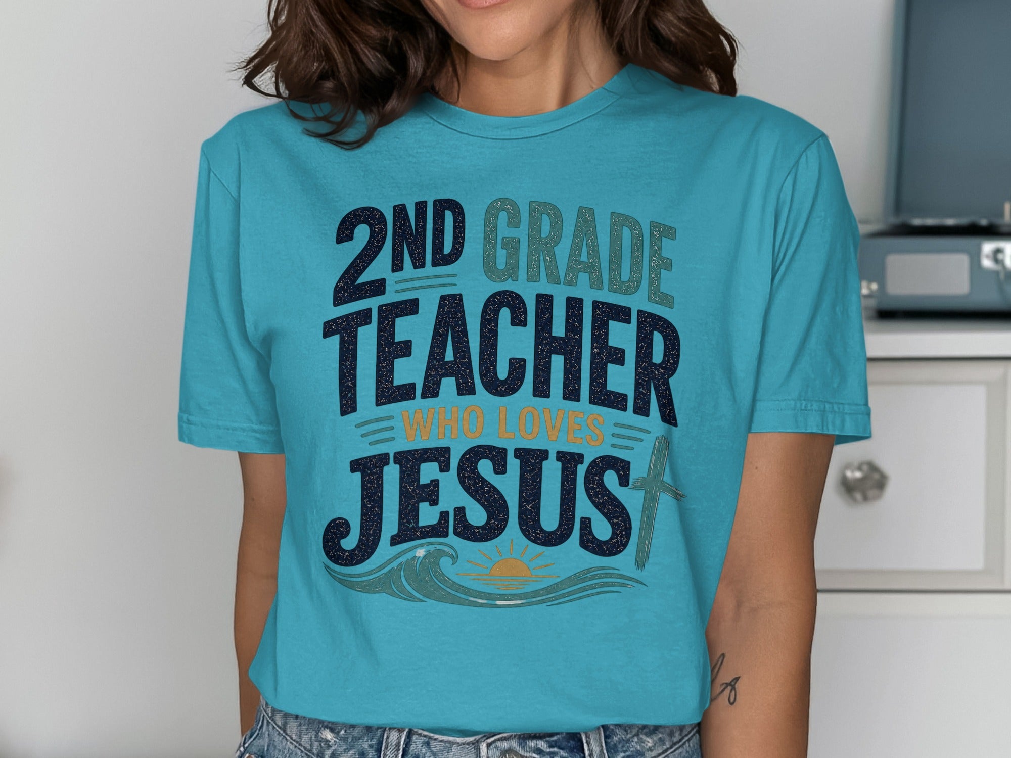 Blue t-shirt with "2nd Grade Teacher Who Loves Jesus" graphic.