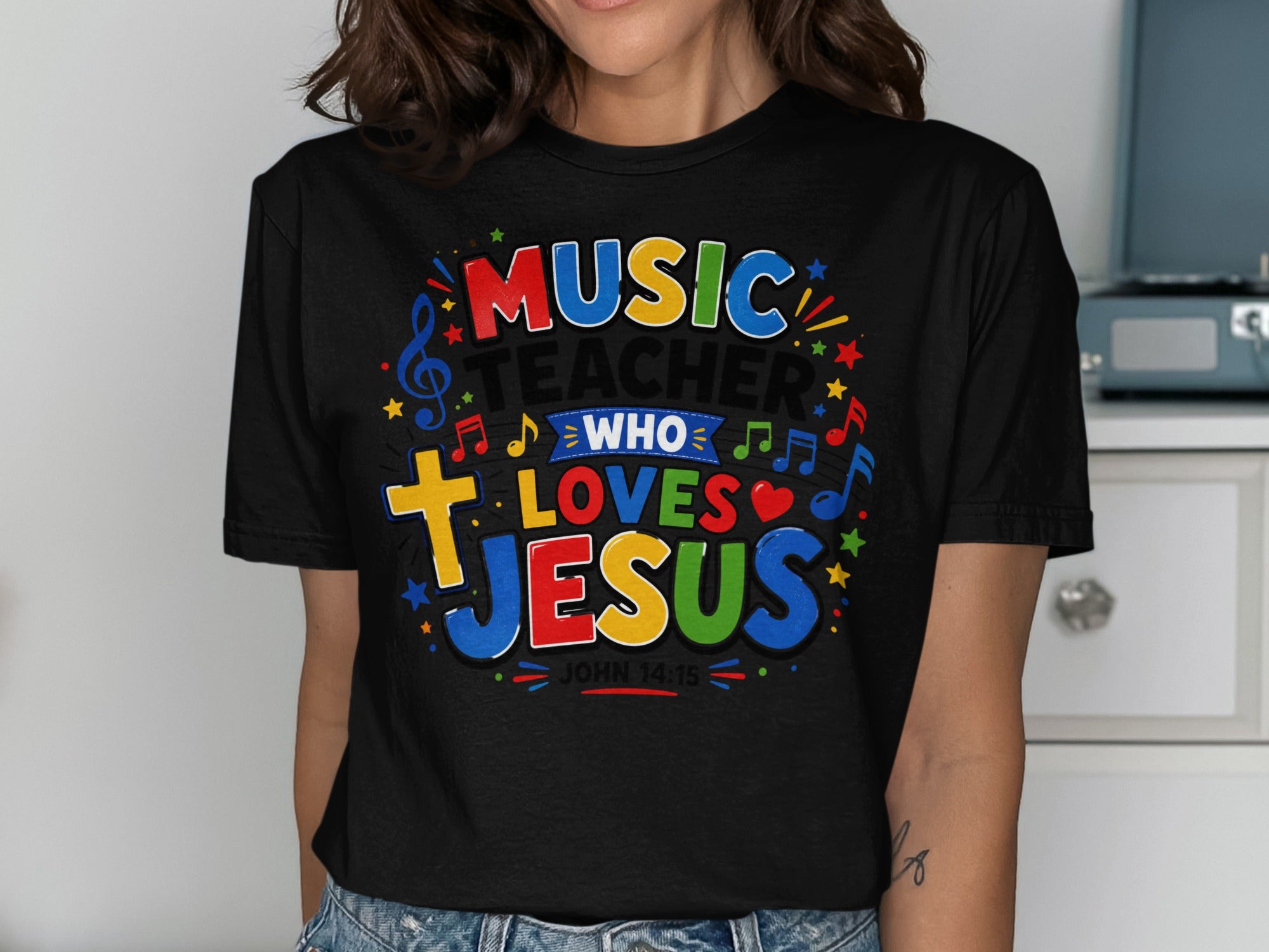 T-shirt with colorful text: Music Teacher Who Loves Jesus, John 14:15.