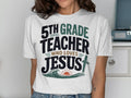 White t-shirt with "5th Grade Teacher Who Loves Jesus" text and a cross.