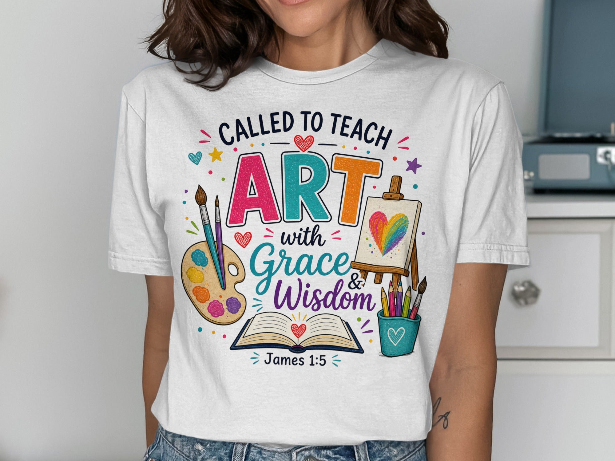 T-shirt with "Called to Teach ART with Grace & Wisdom James 1:5" and art supplies.