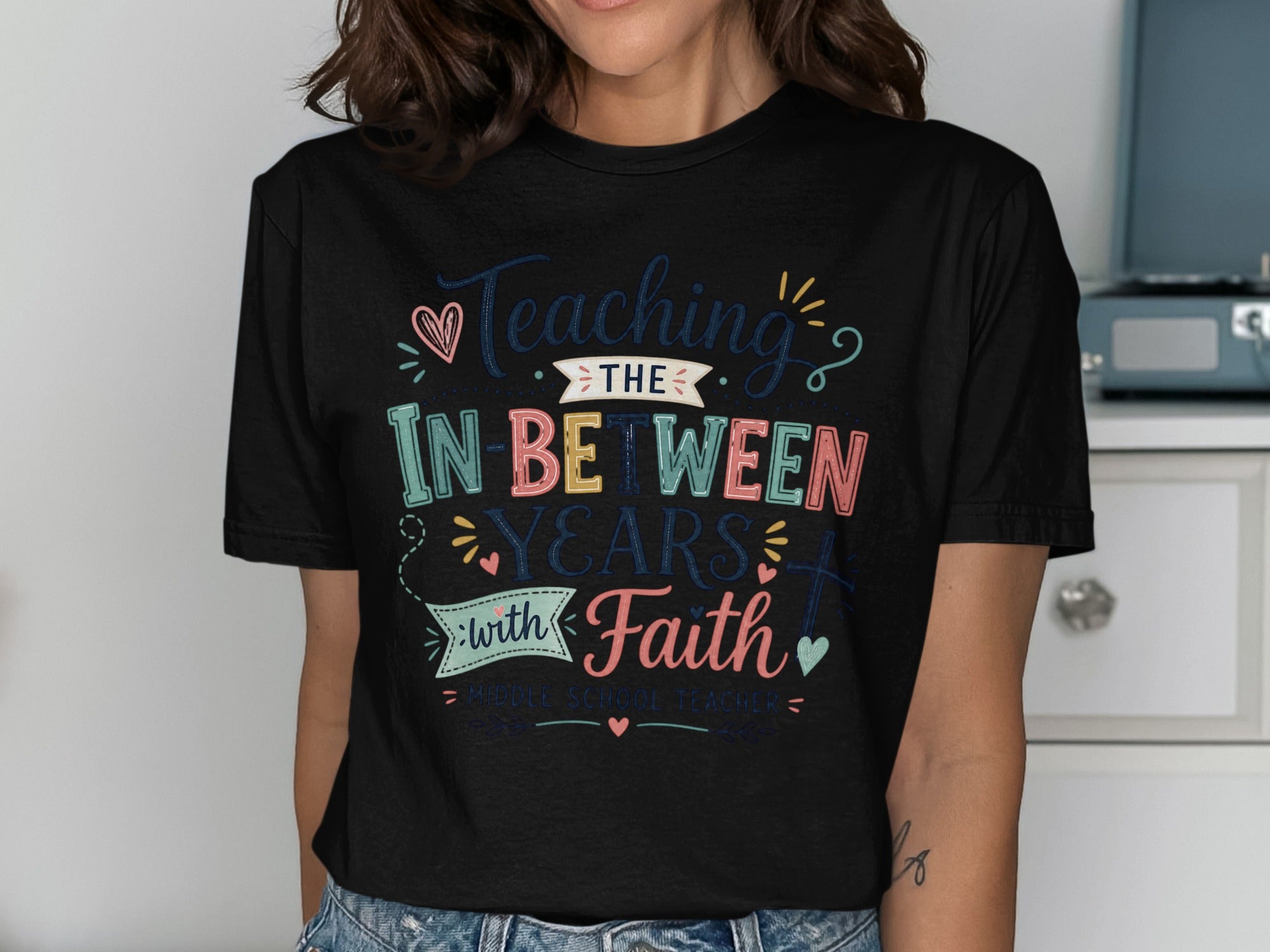 Black t-shirt with "Teaching in Between Years with Faith" text for middle school teachers.