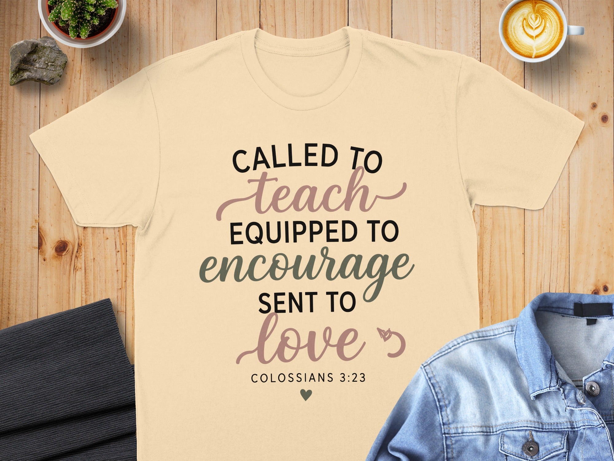 Cream t-shirt with "Called to Teach, Equipped to Encourage, Sent to Love" and "Colossians 3:23".