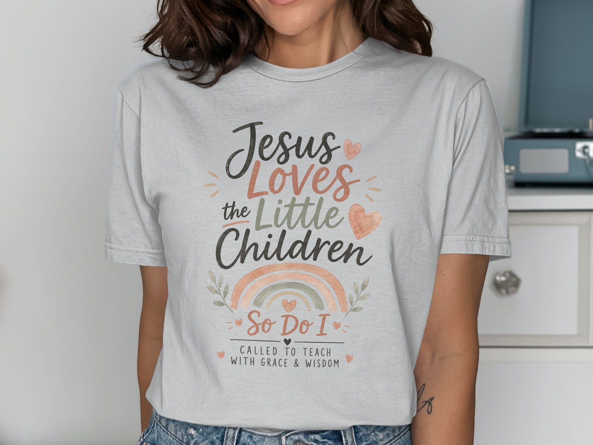 T-shirt with "Jesus Loves the Little Children" text and rainbow graphic.