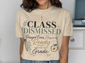 T-shirt with "Class Dismissed" design, featuring school-themed graphics and text.