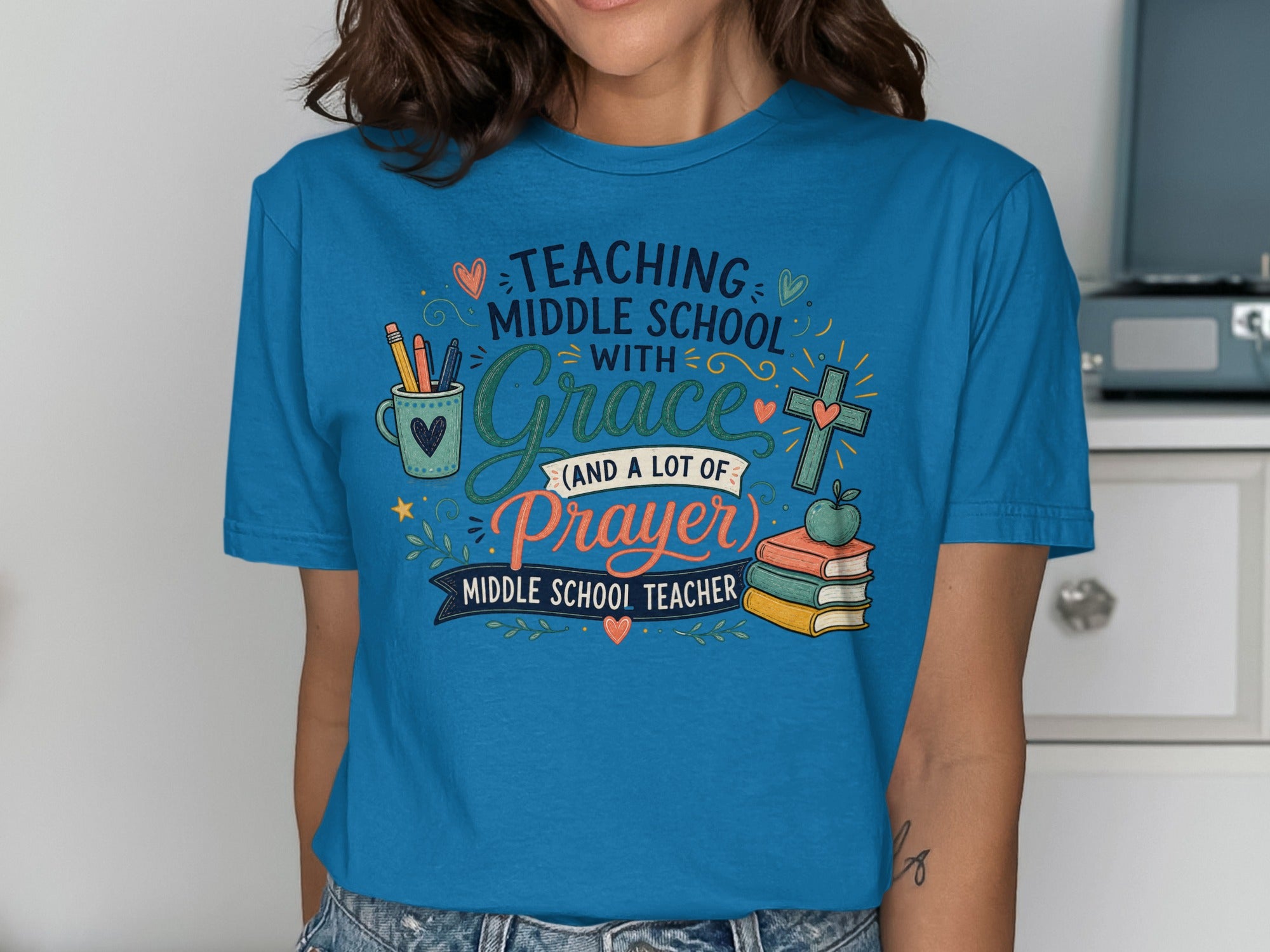 Blue t-shirt with "Teaching Middle School with Grace and a lot of Prayer" text and colorful icons.
