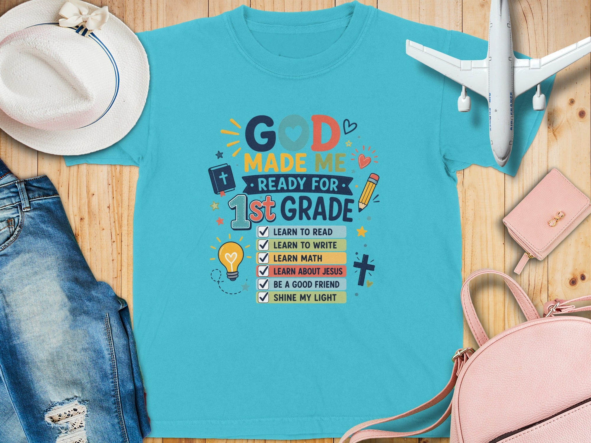 T-shirt with "God Made Me Ready for 1st Grade" and list of school subjects.