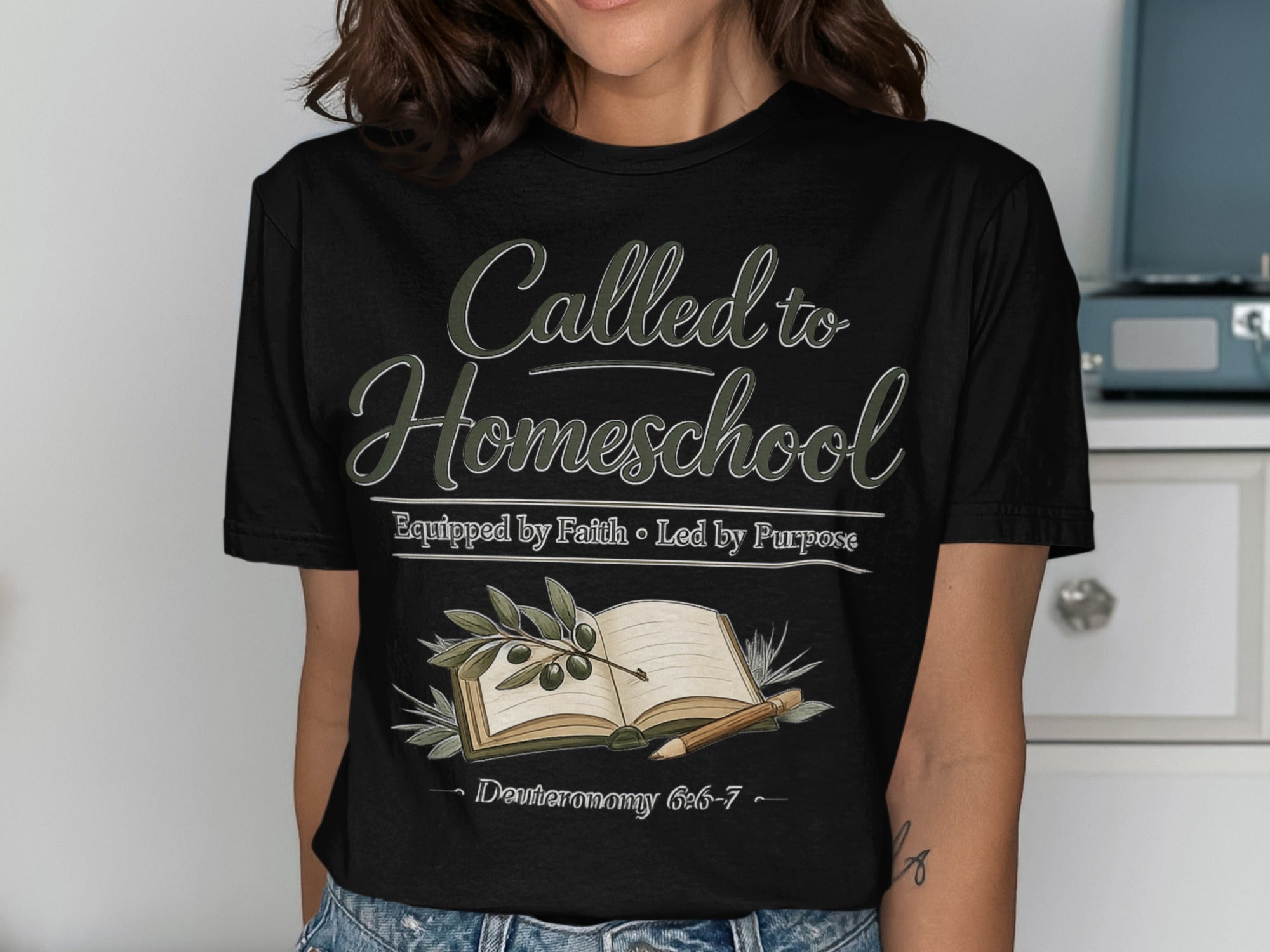Black t-shirt with "Called to Homeschool" and a book with olive branches.