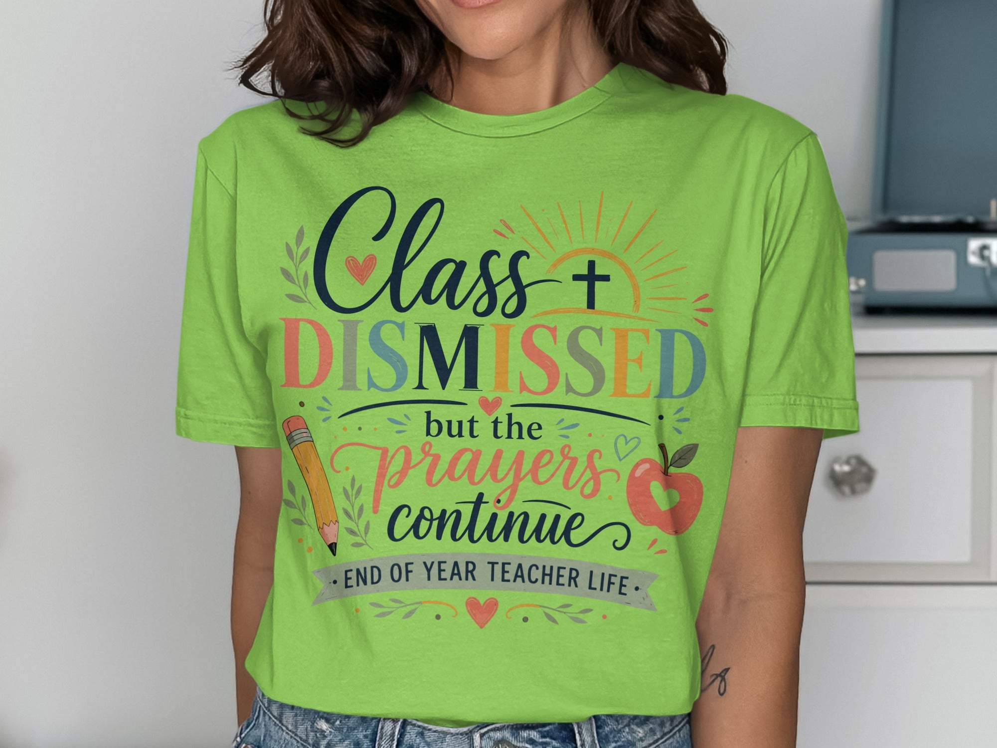 "Class DISMISSED but the prayers continue" graphic on a green t-shirt.