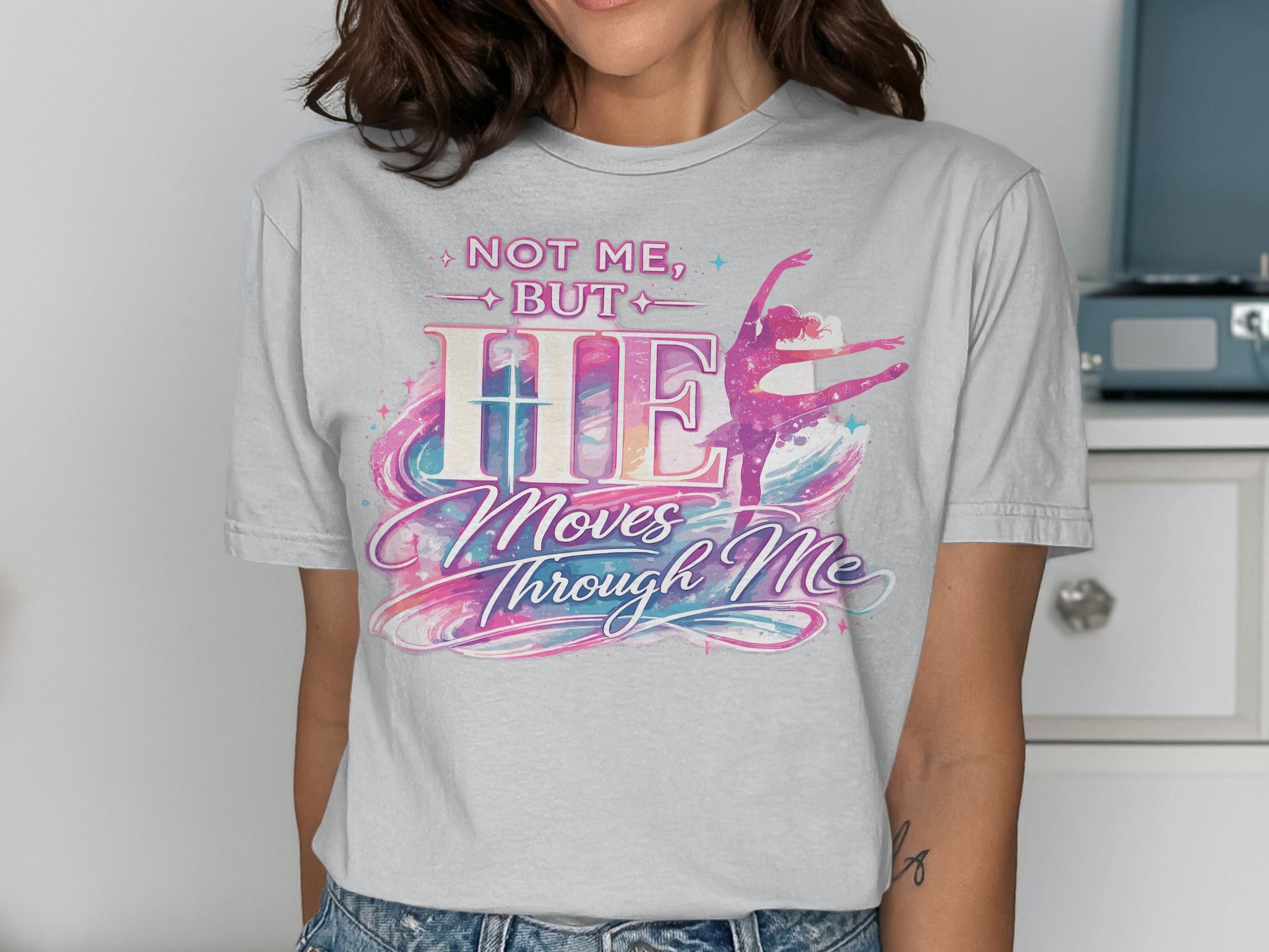 T-shirt with "HE Moves Through Me" and a ballet dancer illustration.