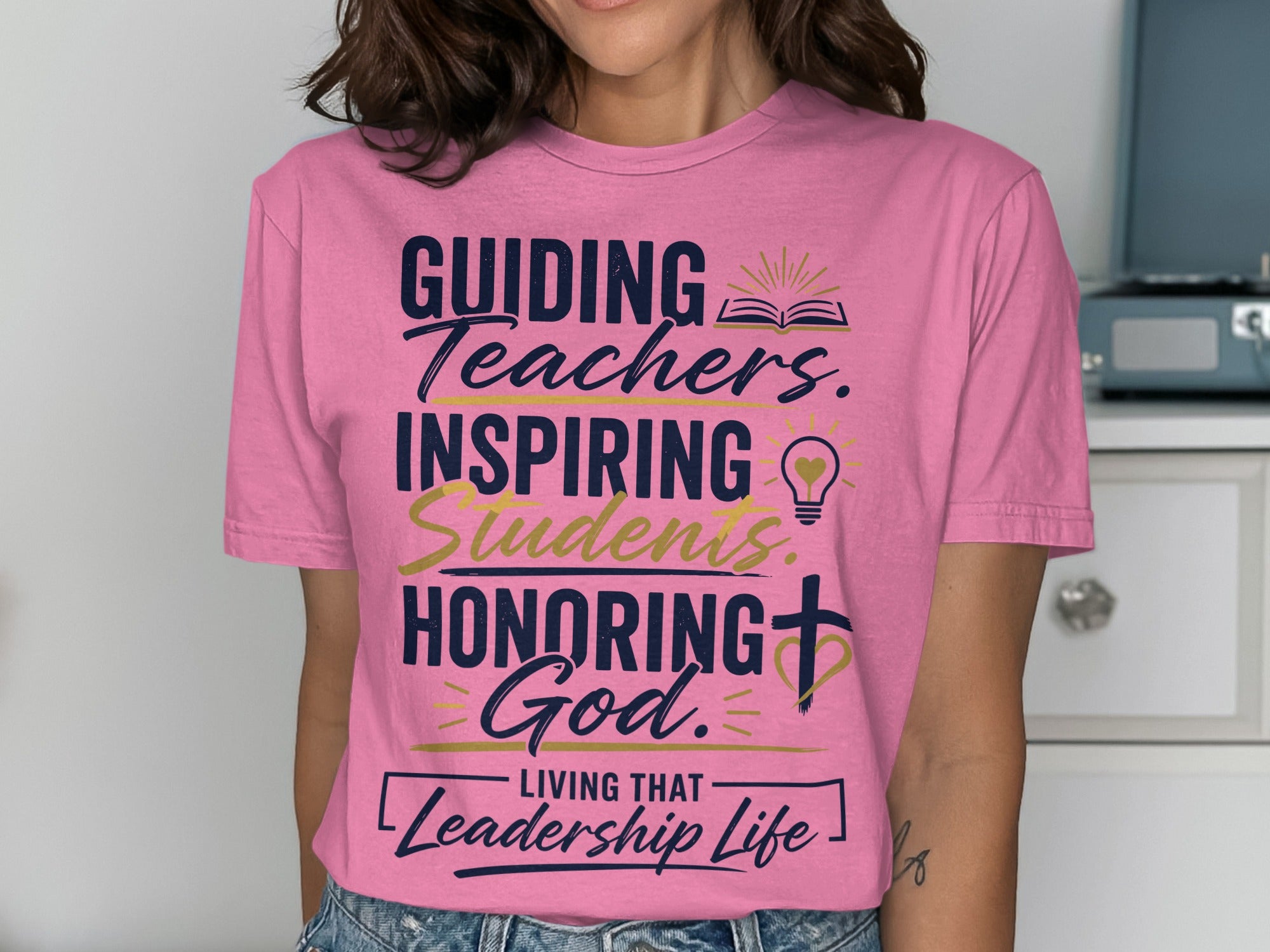 Pink t-shirt with "Guiding Teachers, Inspiring Students, Honoring God" and "Leadership Life".