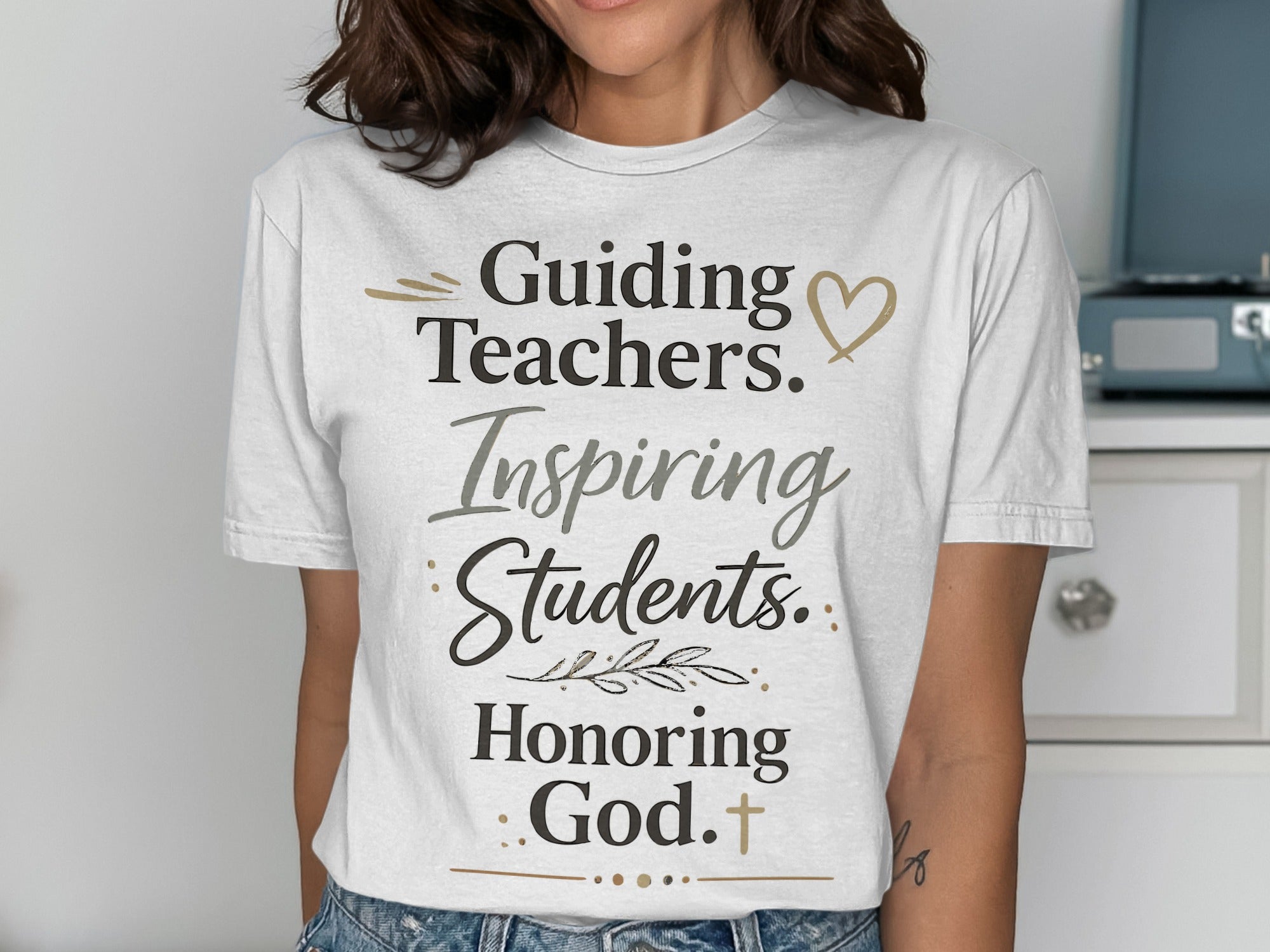 White t-shirt with "Guiding Teachers. Inspiring Students. Honoring God." text.