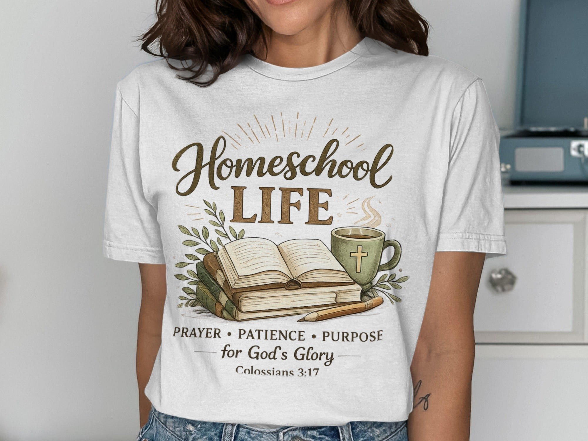 Homeschool Life text on a t-shirt with an open book, coffee mug, and pen.