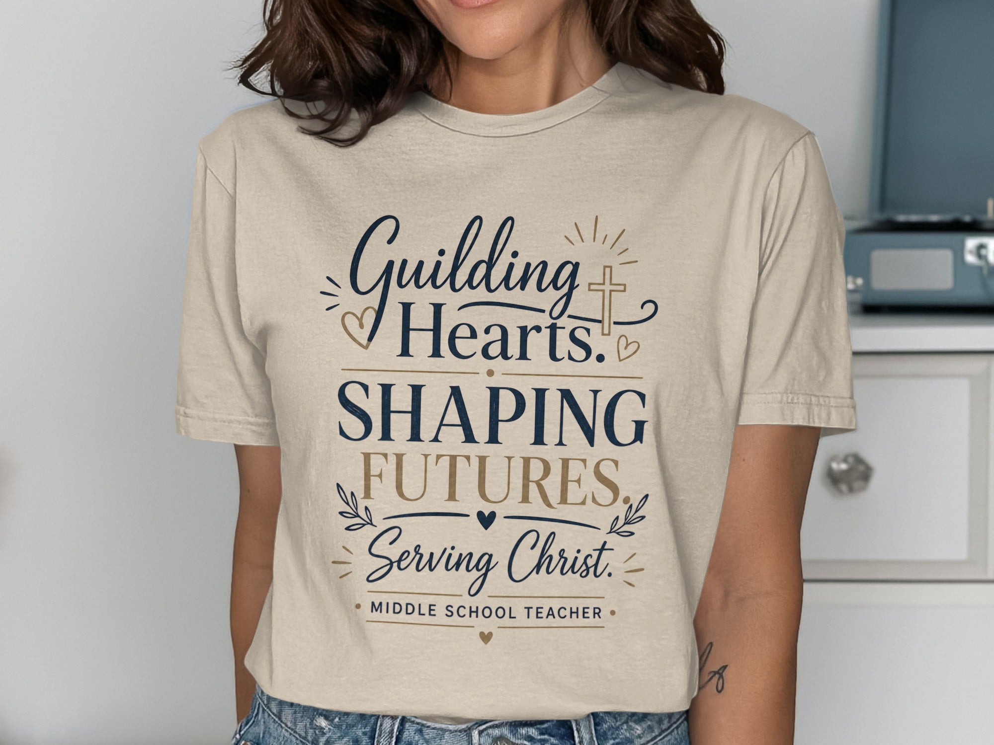 T-shirt with "Guiding Hearts. Shaping Futures. Serving Christ. Middle School Teacher." text.