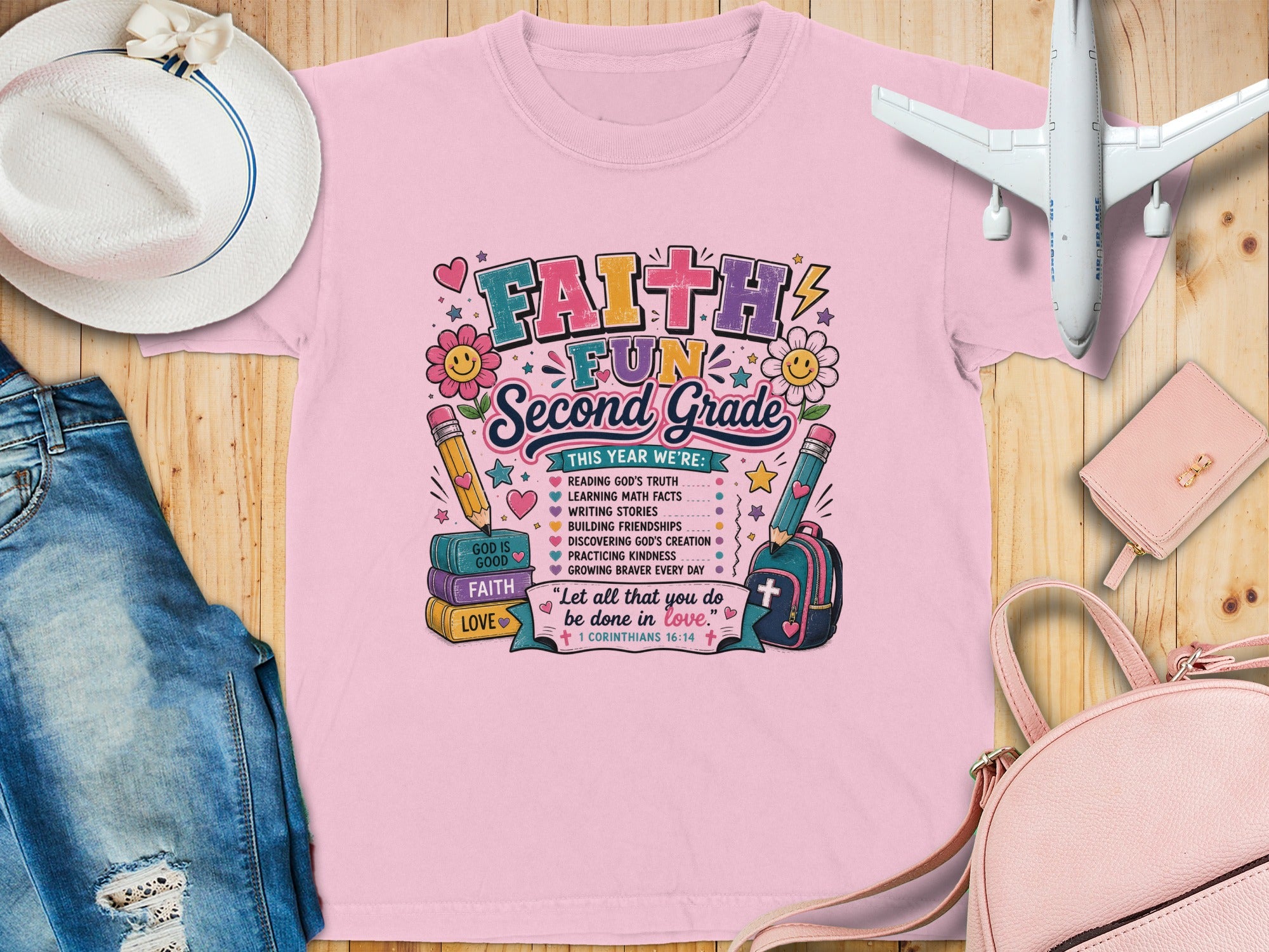 "Faith Fun Second Grade" graphic tee with educational and religious themes.
