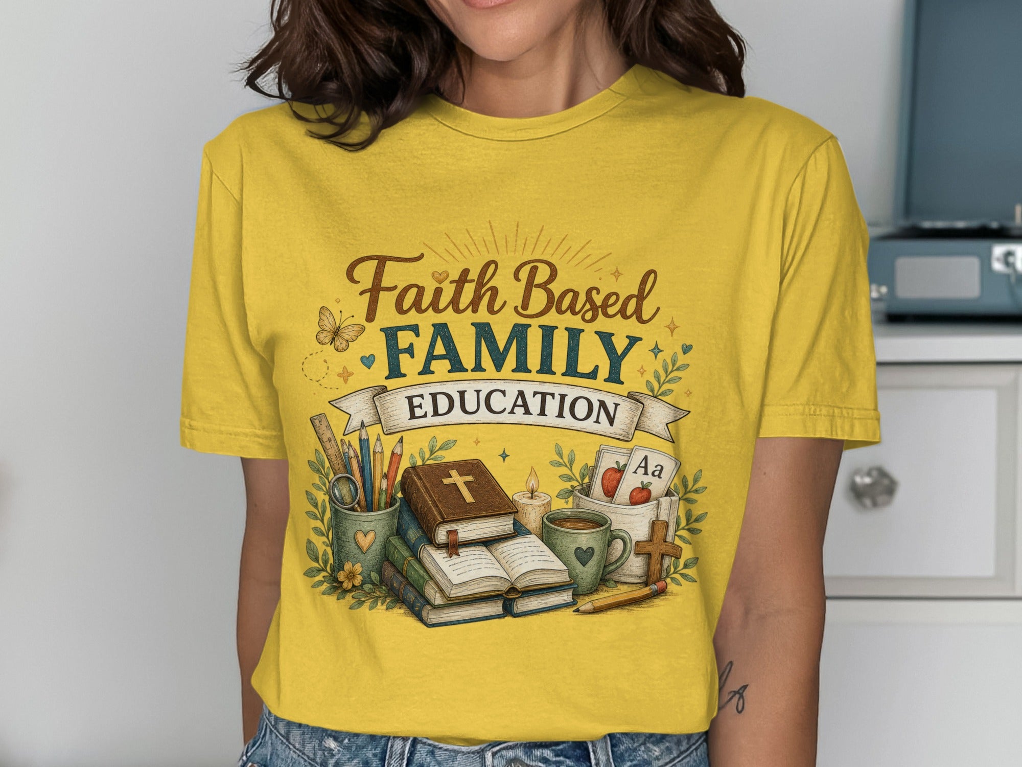 Yellow t-shirt with "Faith Based Family Education" text and school-themed illustrations.