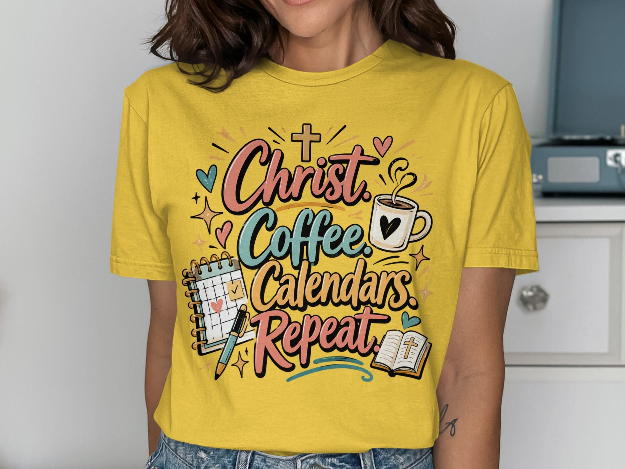Yellow t-shirt with "Christ Coffee Calendars Repeat" graphic.