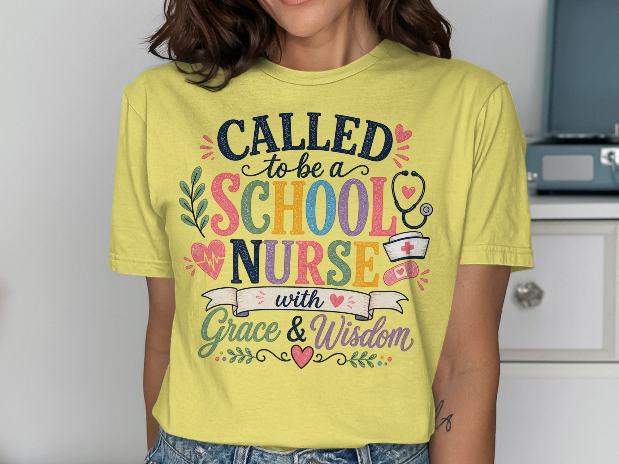 Yellow t-shirt with "Called to be a School Nurse with Grace & Wisdom" text and medical icons.