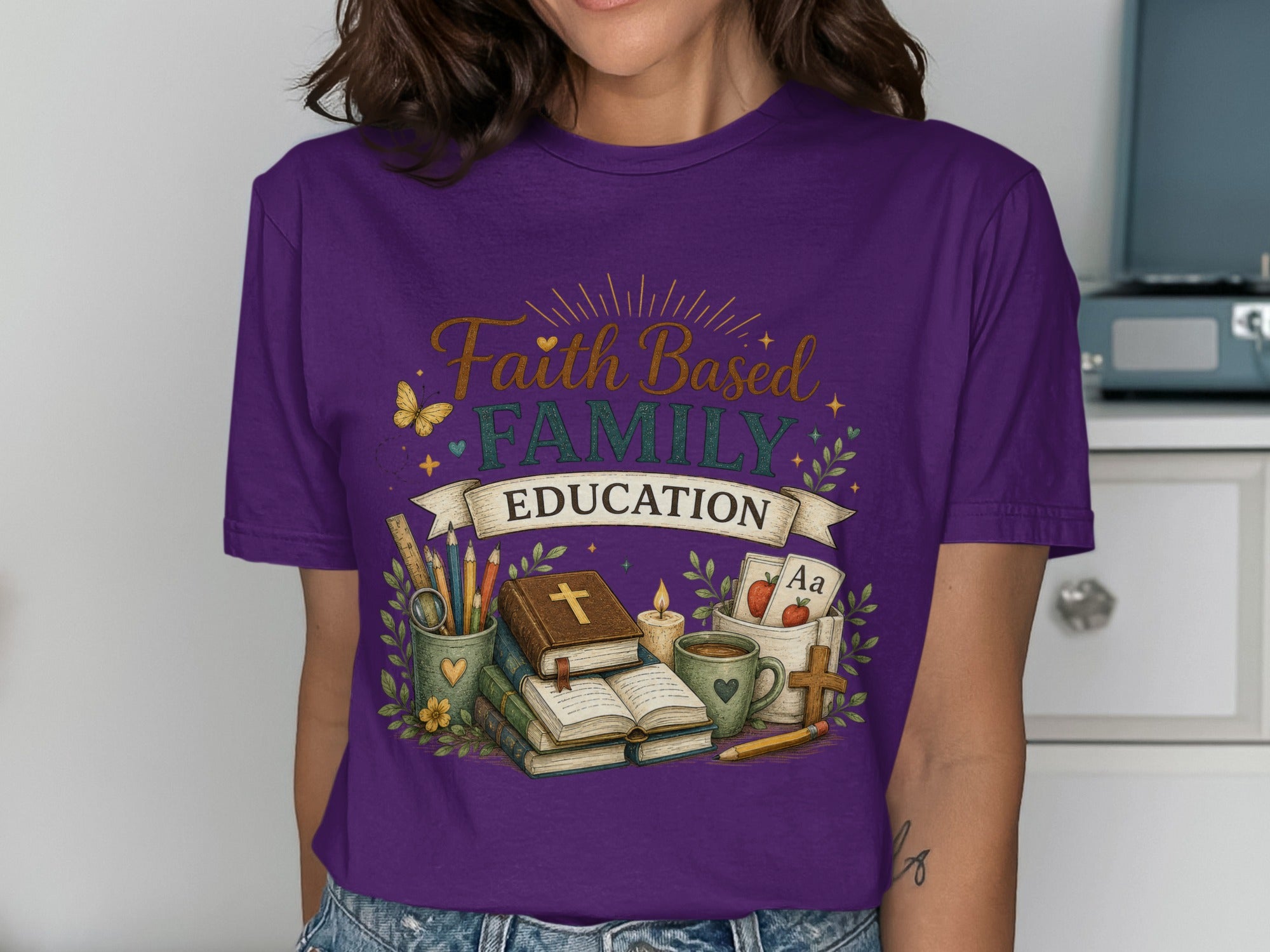 Purple t-shirt with "Faith Family Education" text and school-themed illustrations.