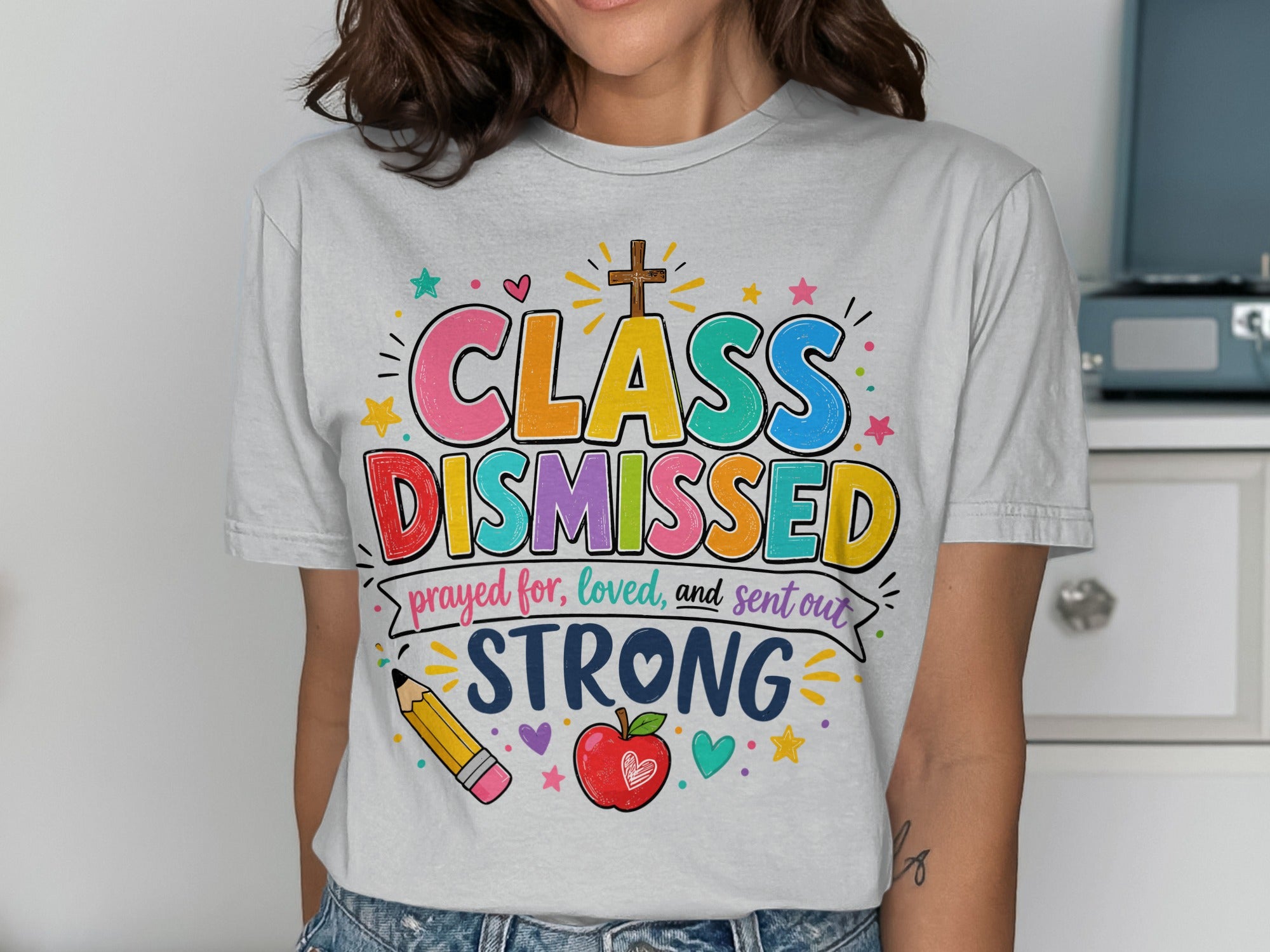T-shirt with "Class Dismissed" text, cross, apple, and pencil.