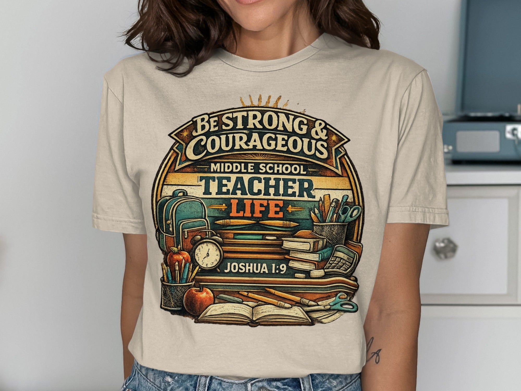 T-shirt with "Be Strong & Courageous Middle School Teacher Life" text, books, and school supplies.