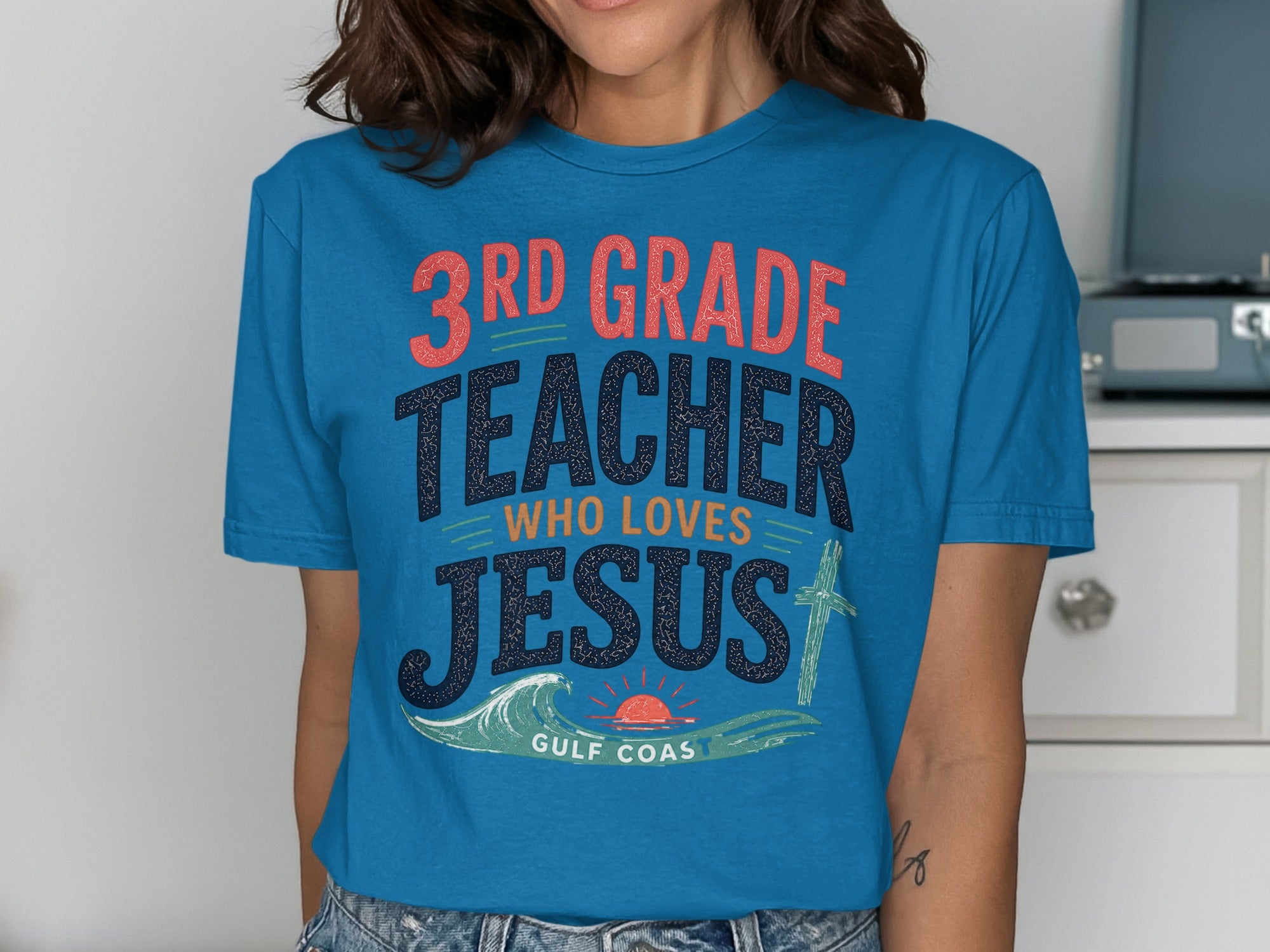 Blue t-shirt with text "3rd Grade Teacher Who Loves Jesus" and "Gulf Coast".