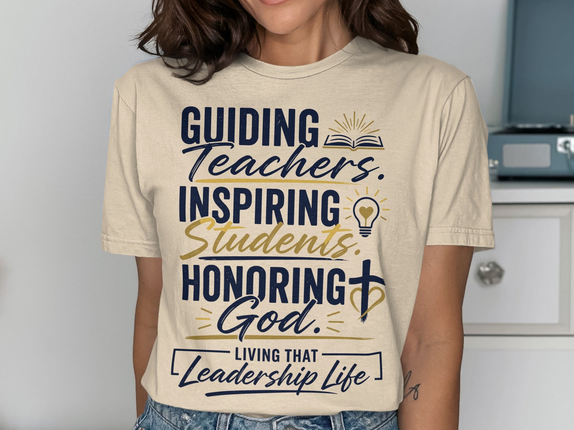 T-shirt with "Guiding Teachers. Inspiring Students. Honoring God. Living that Leadership Life." text.