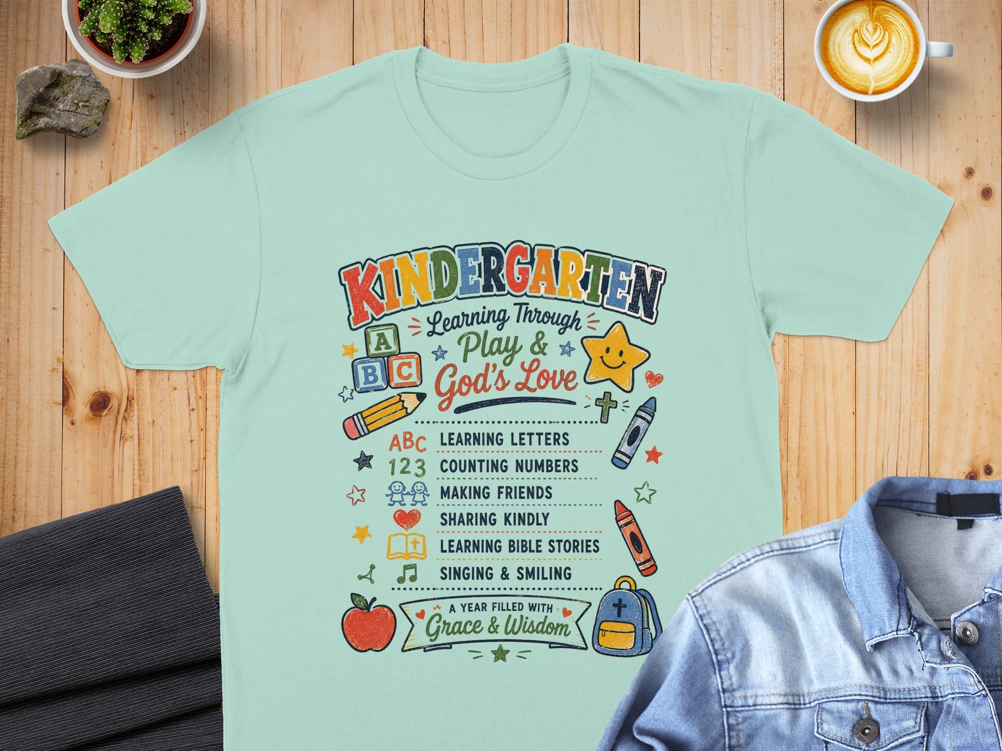 Kindergarten shirt with list of learning activities: ABCs, numbers, friends, Bible stories, singing.