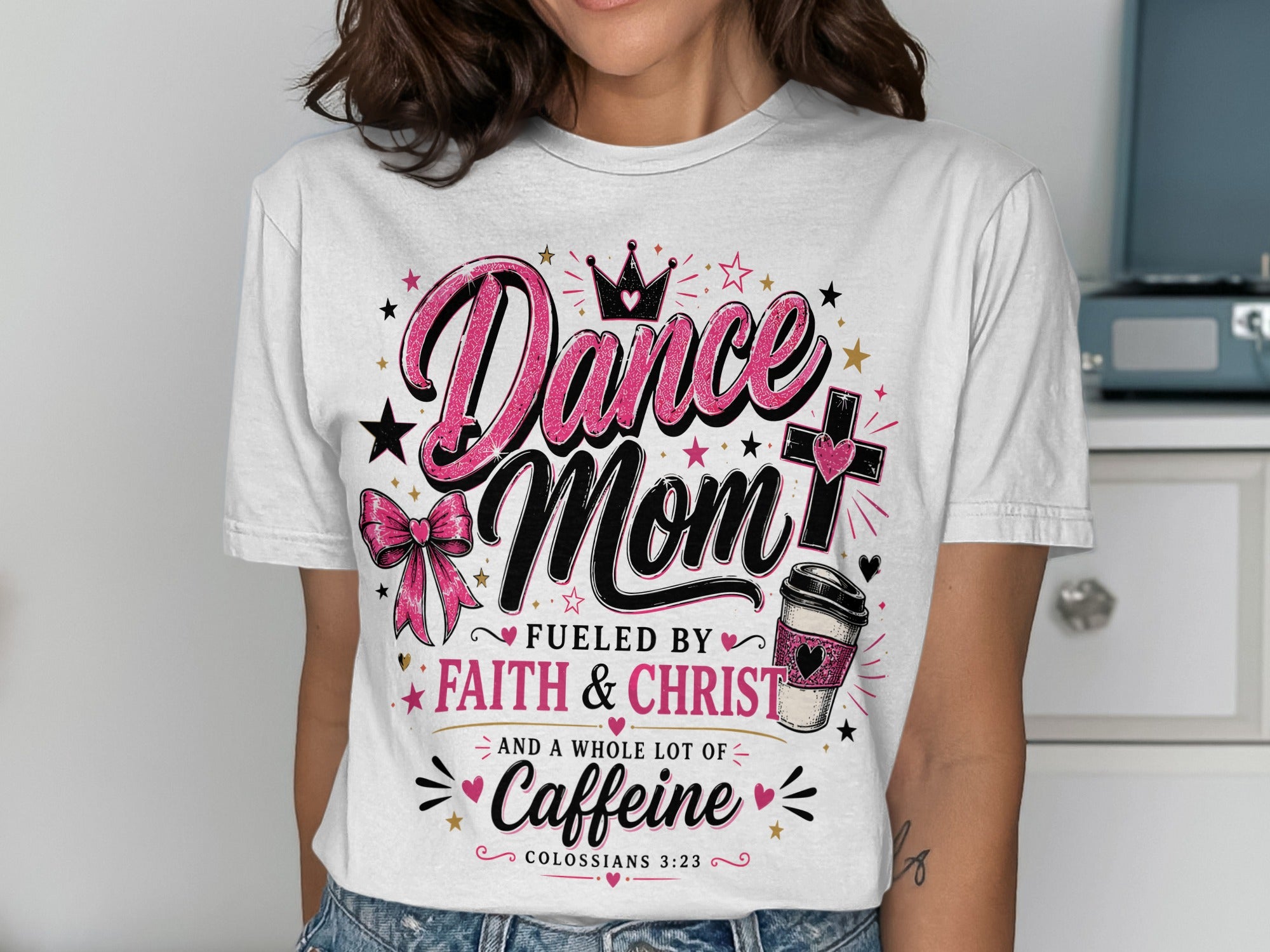 White t-shirt with "Dance Mom Fueled by Faith & Christ and a whole lot of Caffeine" text.